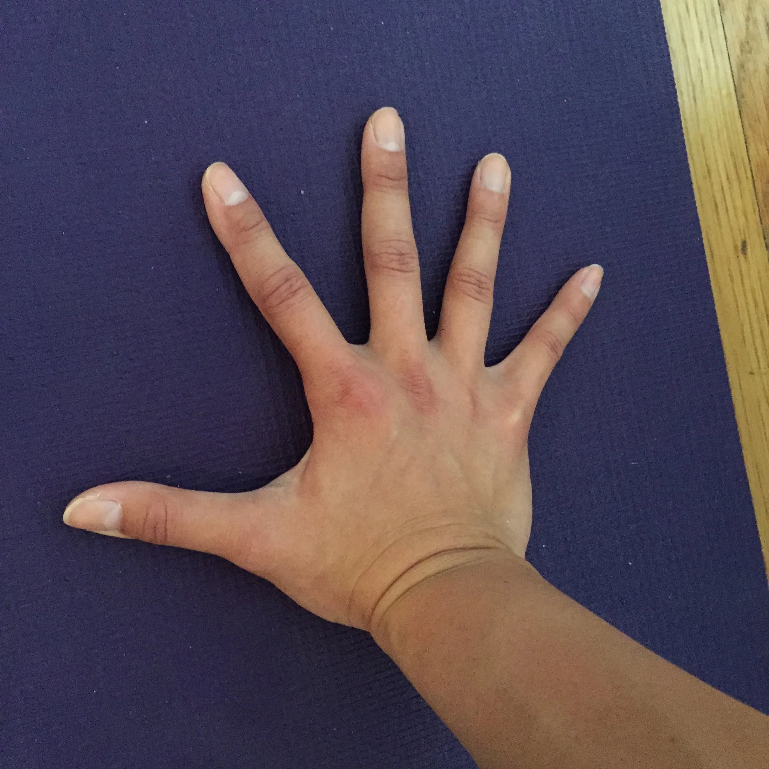 Correct option: Fingers are spread out and grounded through the inner palms. Think of your arms, hands, and fingers as an extension of the core, and you are pressing the hands into the floor from your core. 