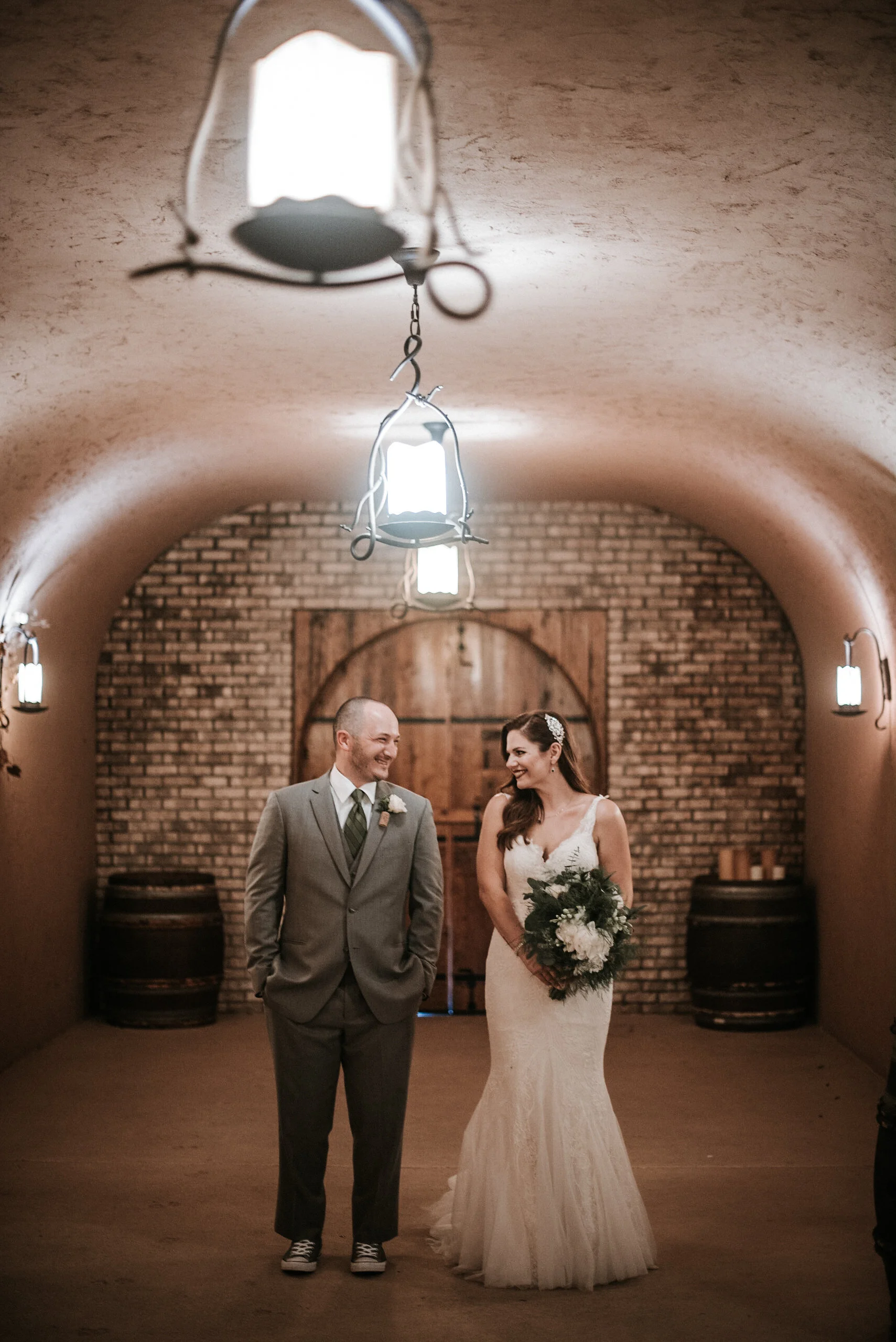 Couple+locking+eyes+in+wine+cellar.jpeg