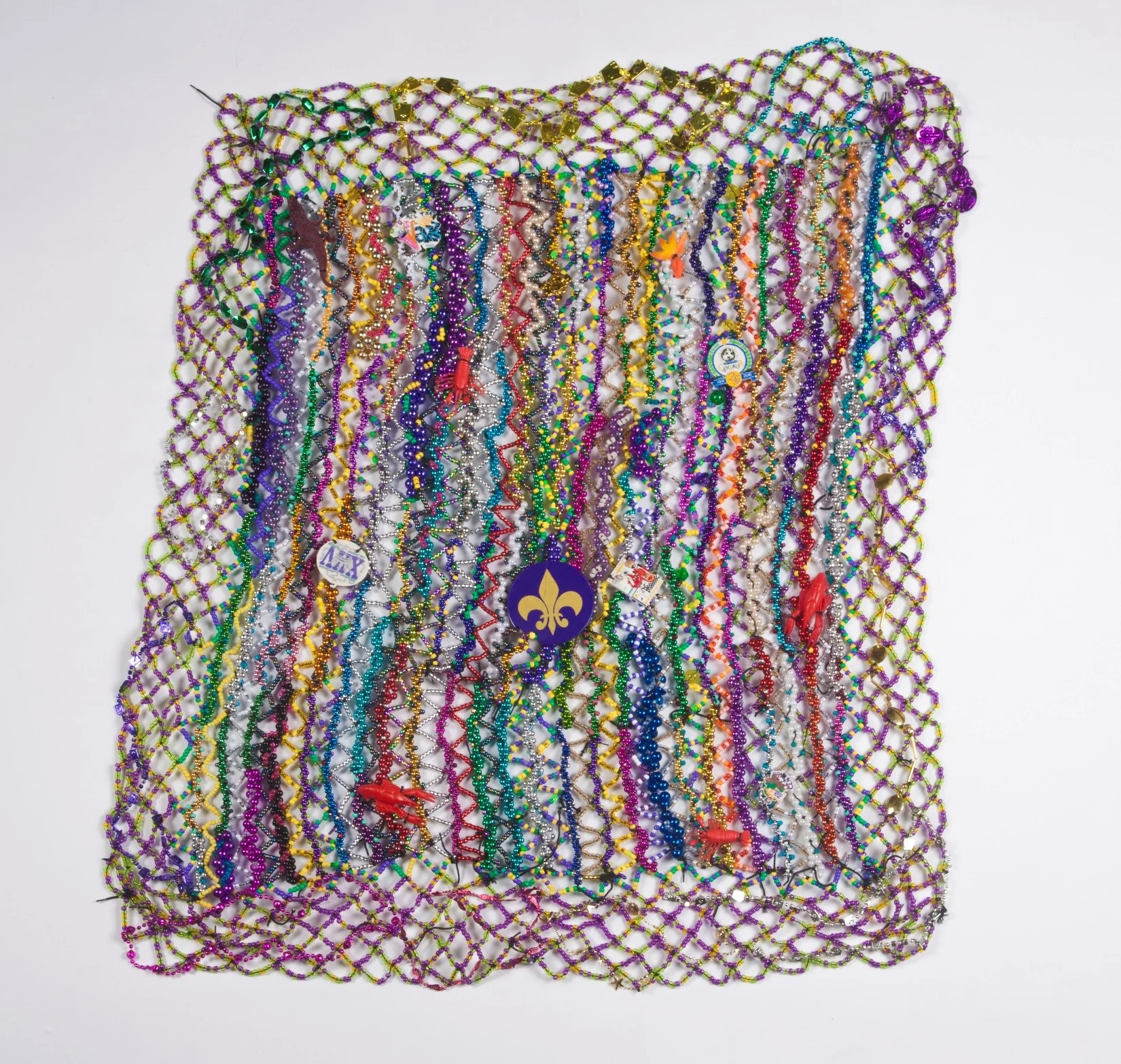 #16 - Mardi Gras Blanket Sherry Tamburo and Heather Beauvais In celebration of Mardi Gras this blanket was constructed with the help of Providence House residents. Nick Cave’s residency gave us the opportunity to showcase the uniqueness of Louisiana using the souvenirs from Shreveport’s own Mardi Gras parades.