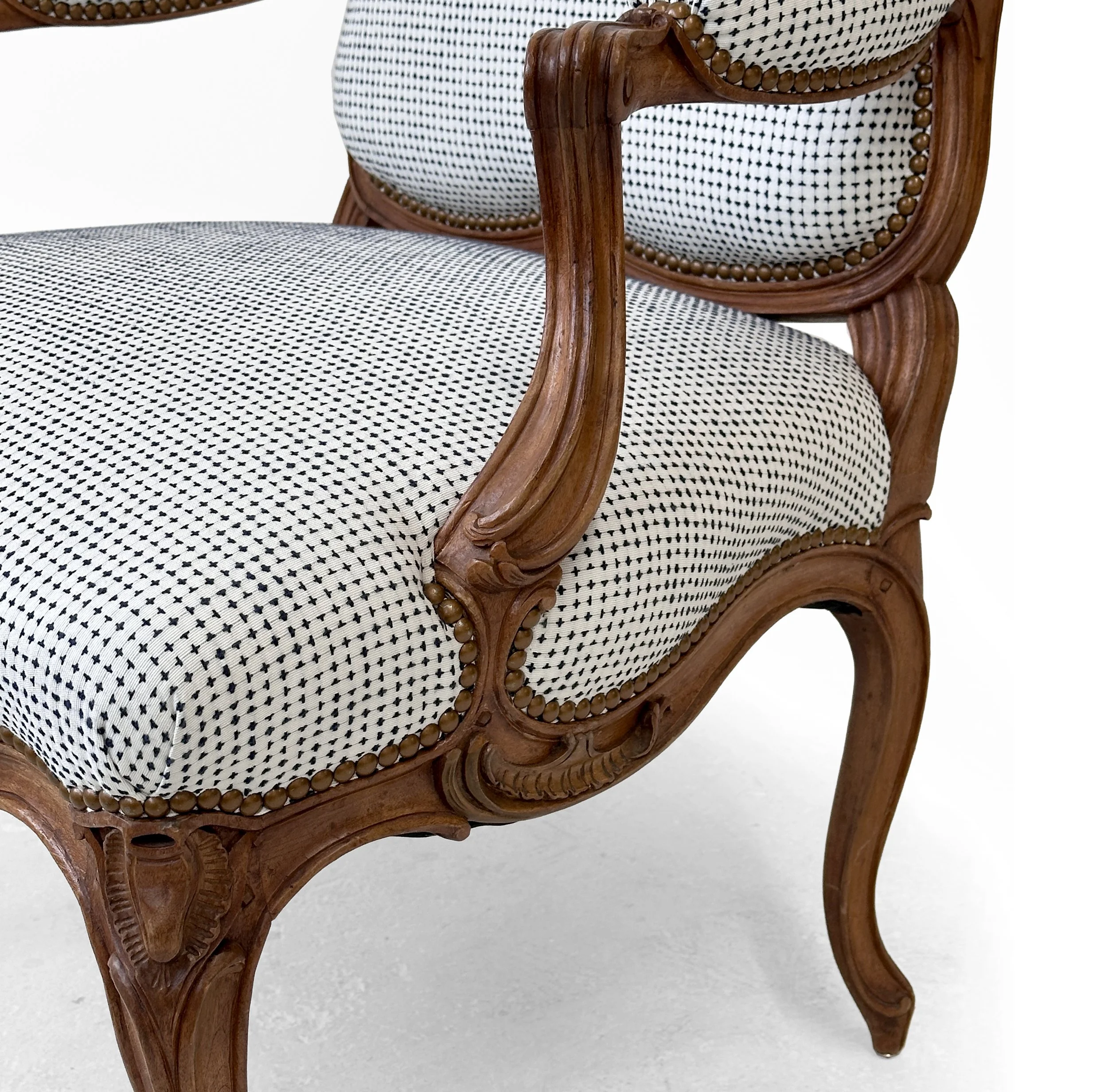 R133-St.-Georges-model-finely-carved-Louis-XV-open-arm-chair-carved-floral-details-and-graceful-curved-silhouettes-Victoria-&-Son-upholstered-Nail-head-trim-scrolls-cabriol.jpg