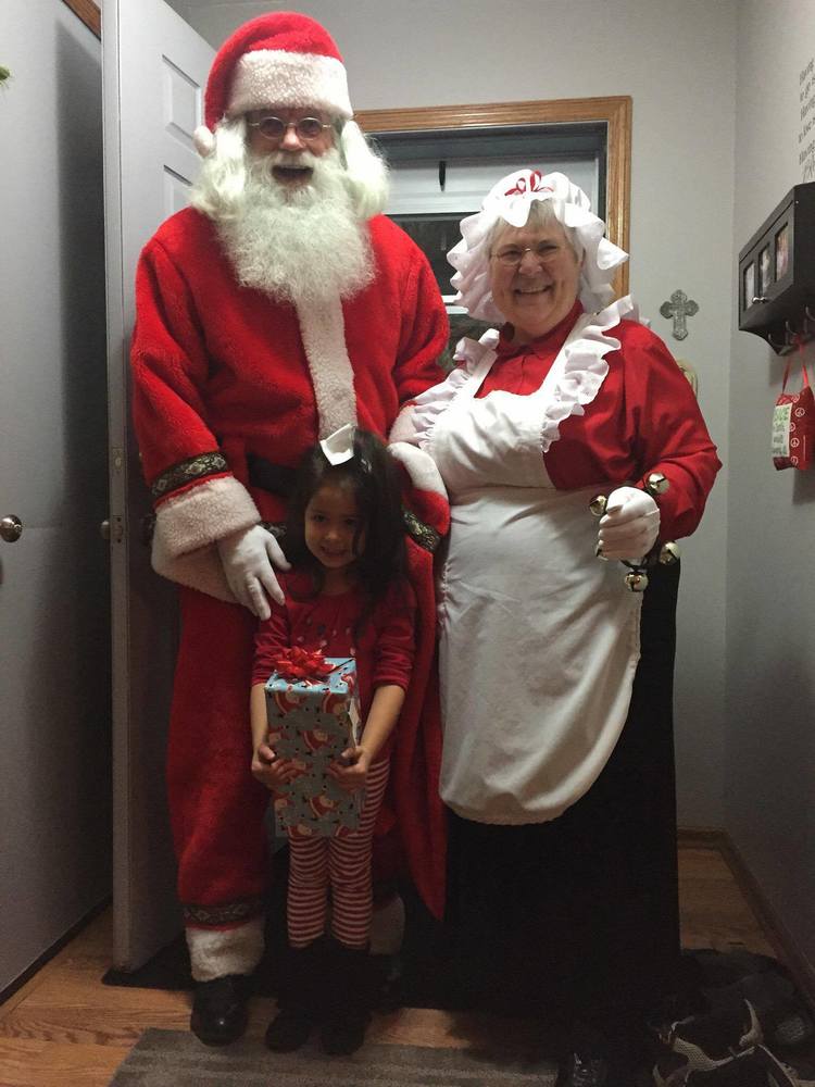 Santa & Mrs. Claus visit a good little girl in her home. 