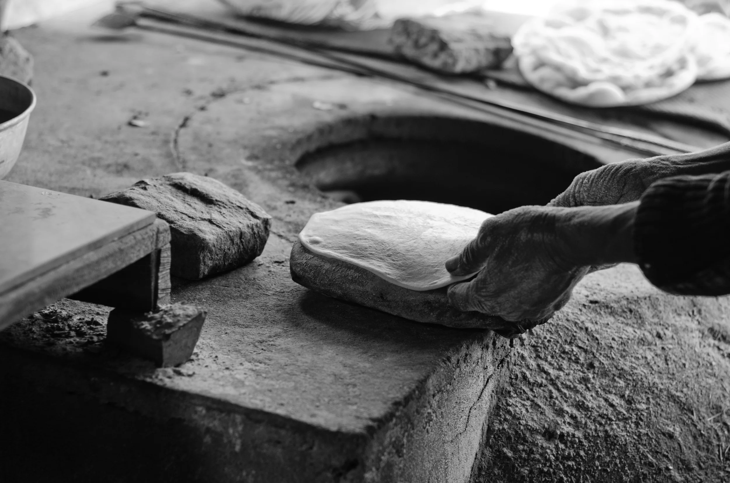 stretching dough onto a damp cloth pouch