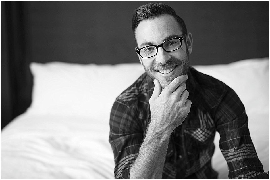 smiling portrait sitting on a bed