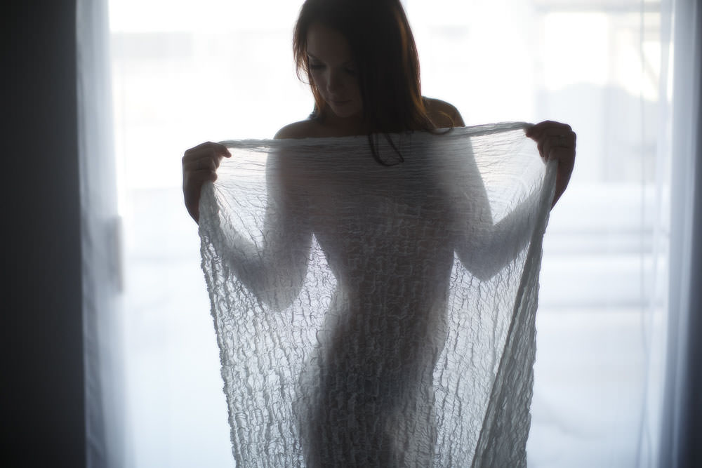 see through sheet used to silhouette the shape of her body