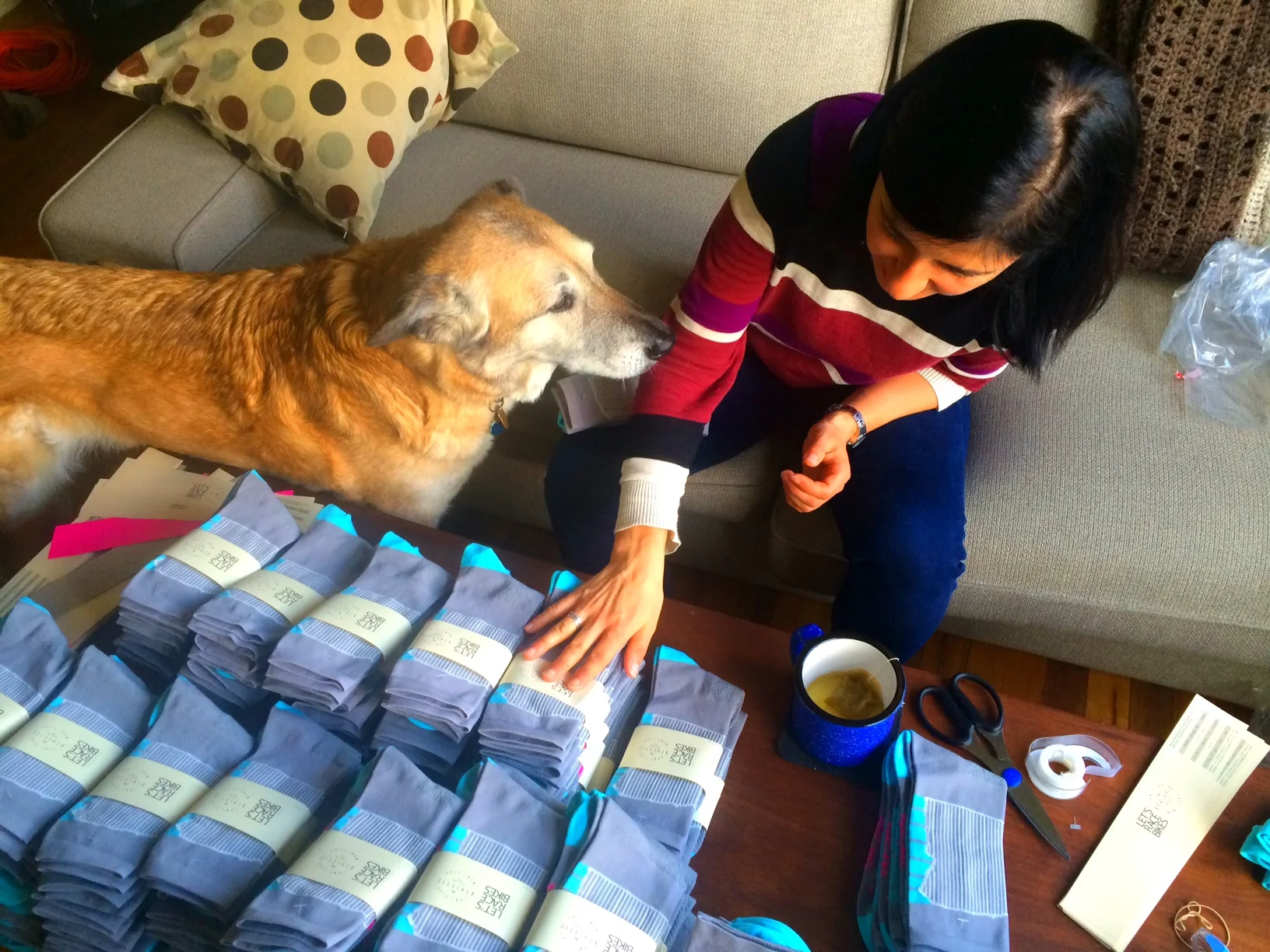 Lolo and Squashy help get the socks dressed up in their labels.