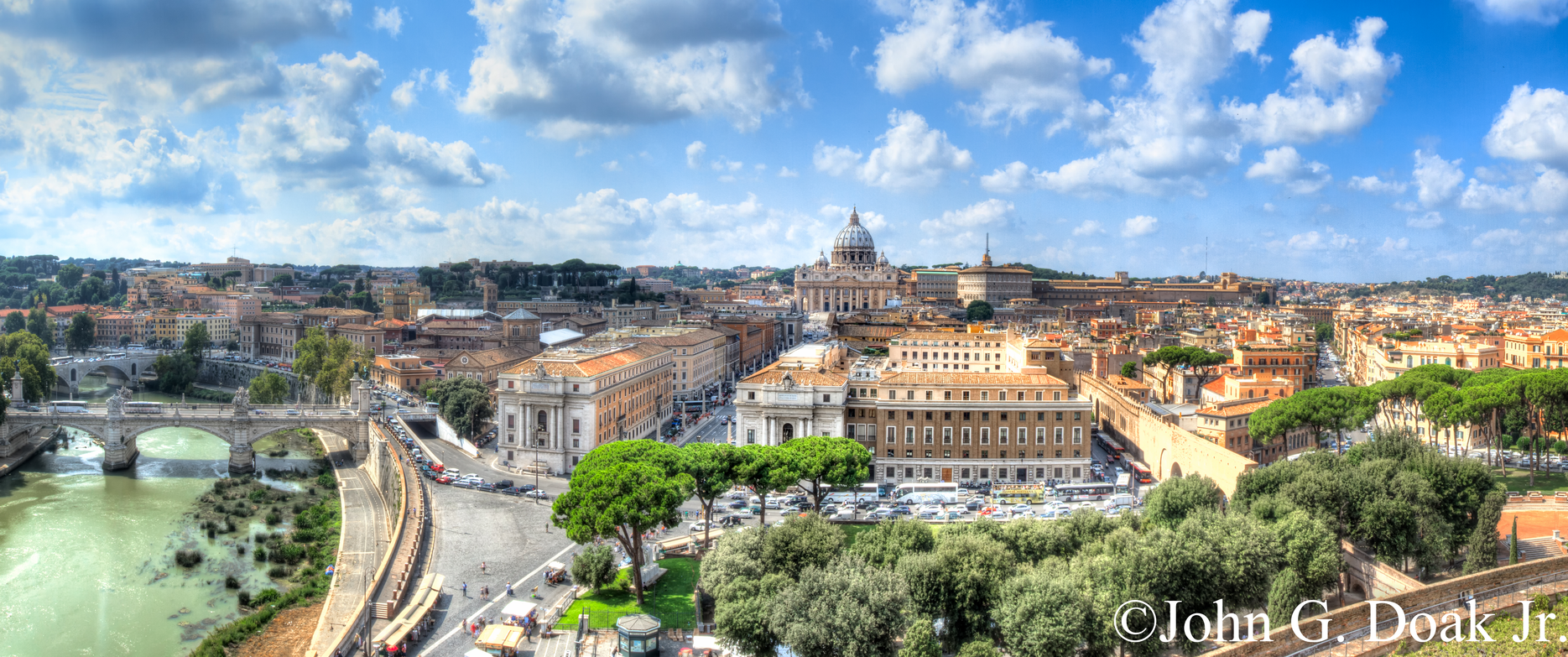 Catalog #12004 Location: Vatican City This is a view of St. Peters from Castel Sant'Angelo. It was a beautiful day with just the right puffy clouds in the sky. Though to be honest, I think I was done climbing stairs for the day, my feet were done before I got here. But some of my friends wanted to go inside. They stated "we don't have to go all the way up", but lets be real: of course you do! Because of them, we have this great picture that I think captures a breathtaking view. This is an HDR panorama shot with a 50mm lens.