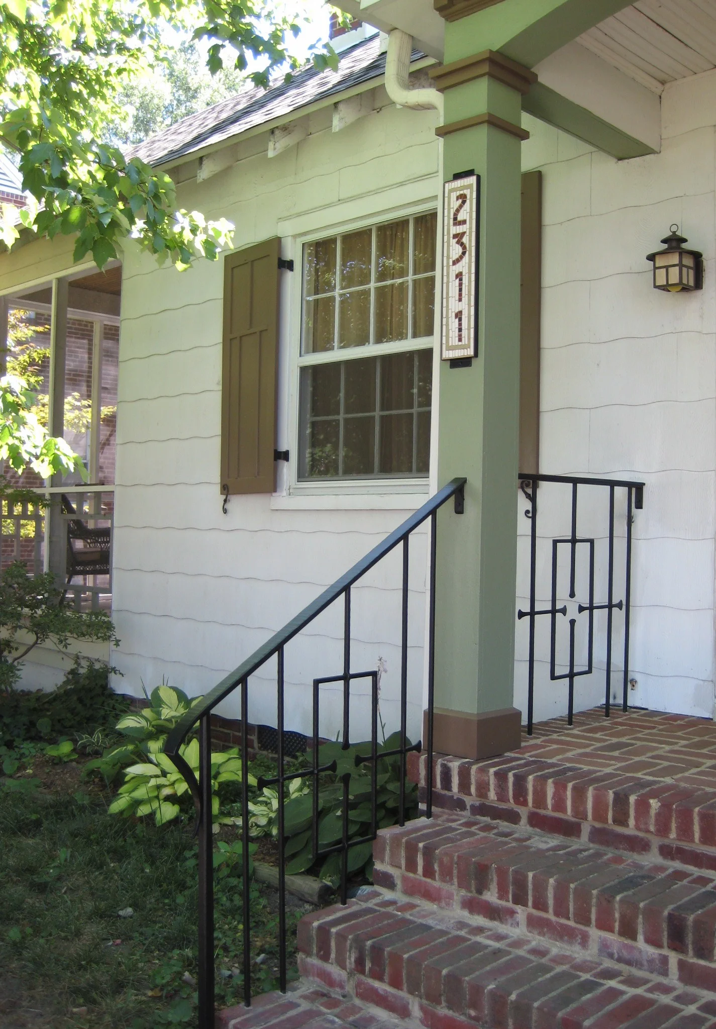 Porch railing, mosaic address plaque, & shutters
