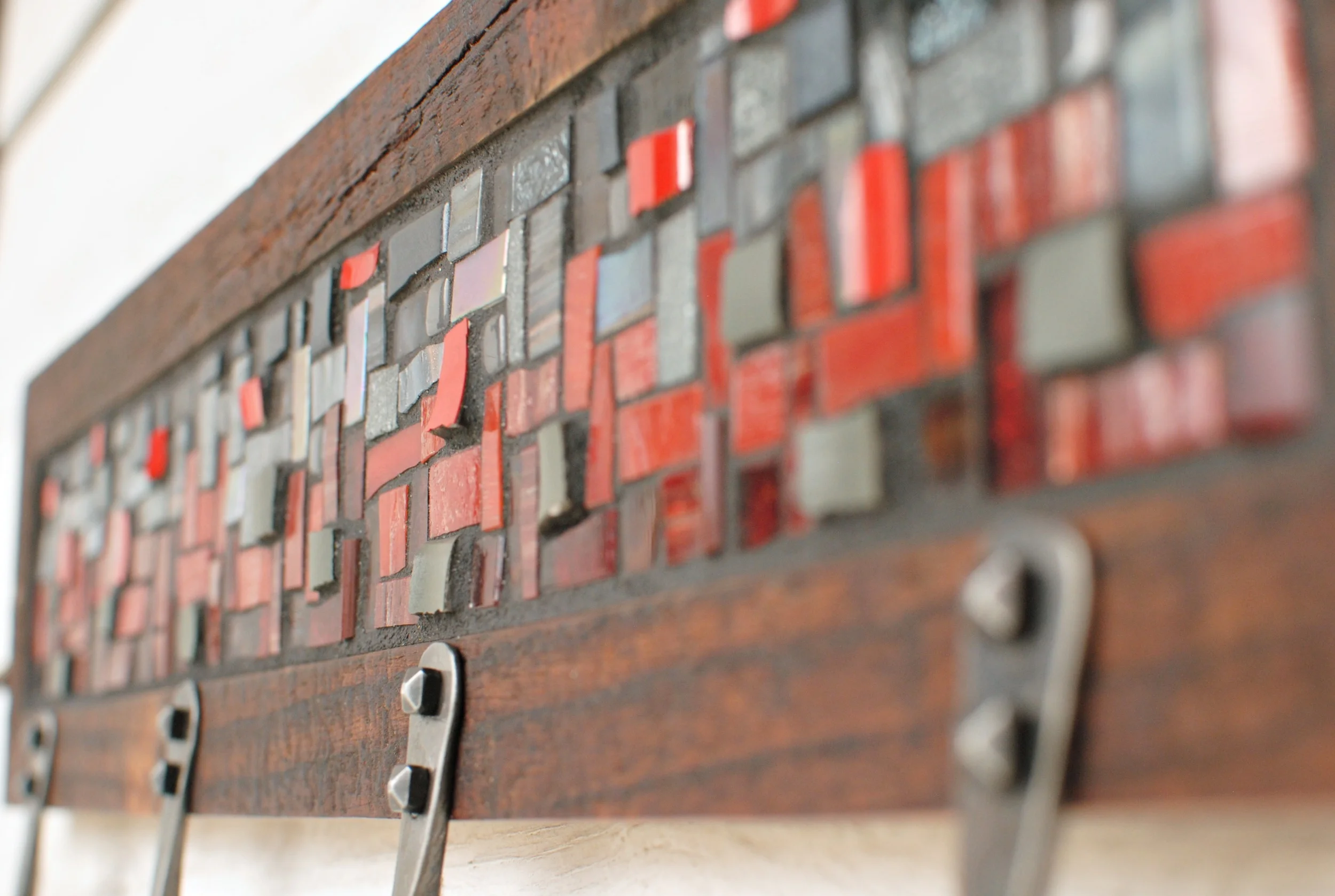Detail of red and gray custom mosaic coat rack