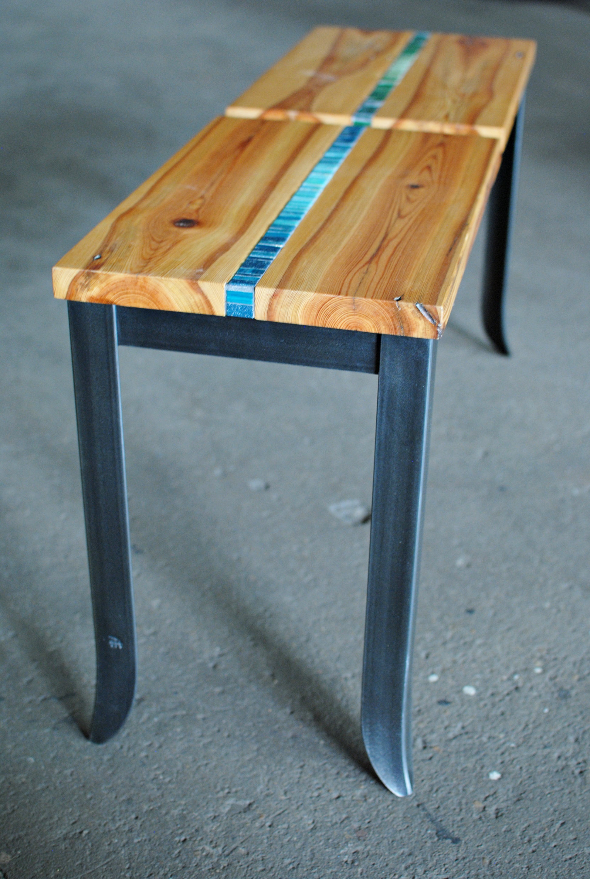 Custom Interior bench with mosaic inlay in wood seats and forged steel legs