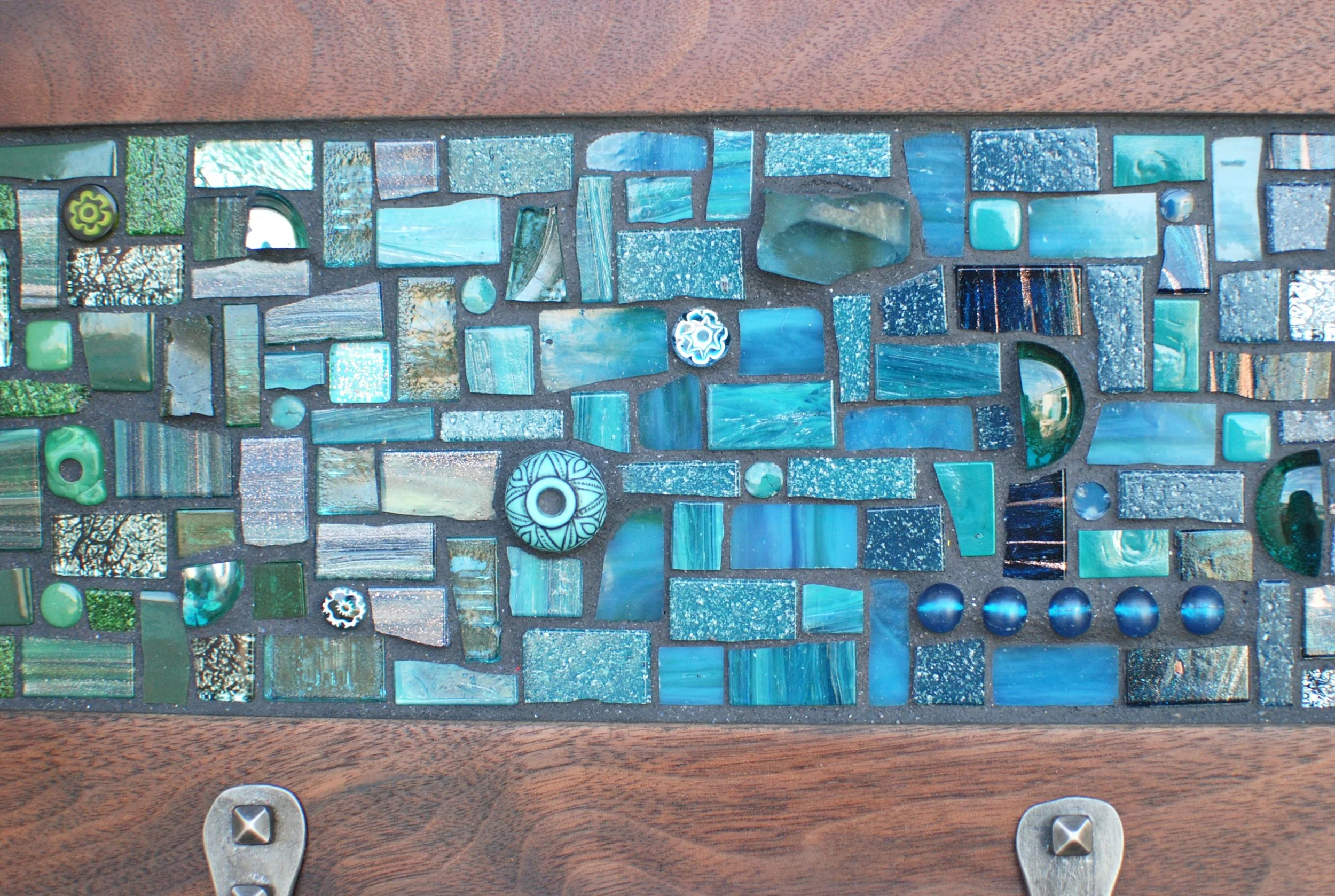 Close-up of large custom turquoise mosaic coat rack
