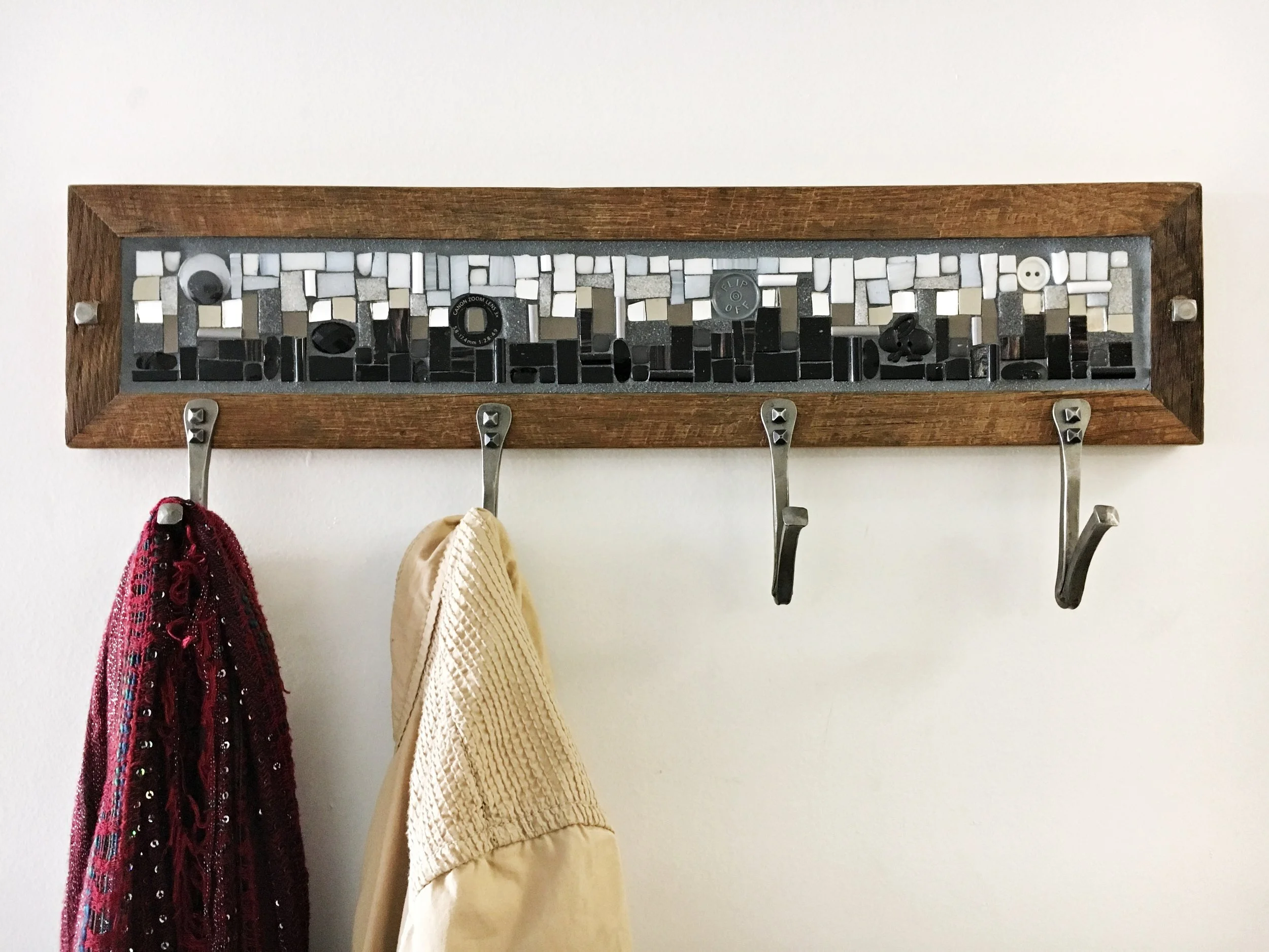 Phoenix Handcraft mosaic coat rack installed with two items hanging from the hooks