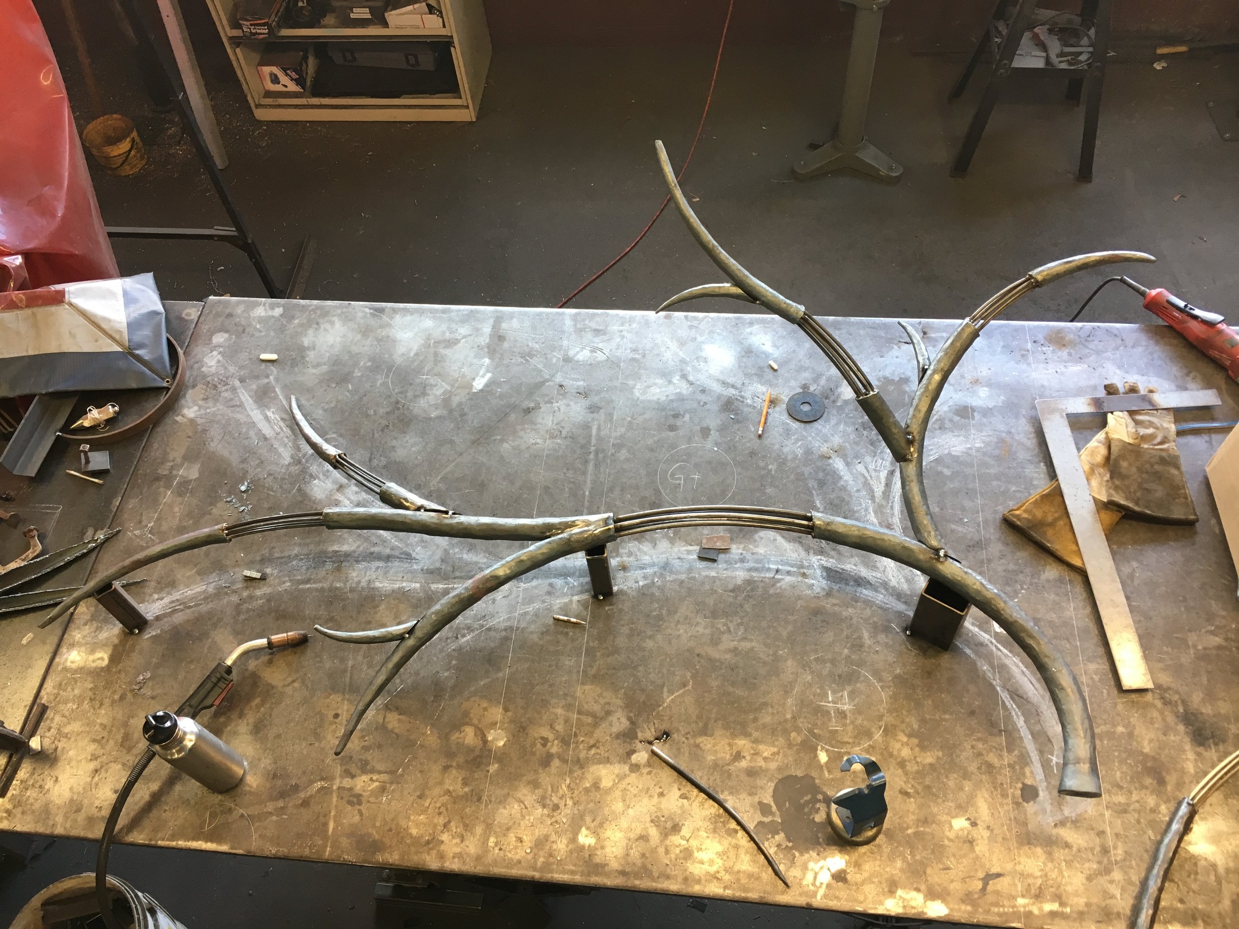 Putting the forged custom chandelier elements together in the studio