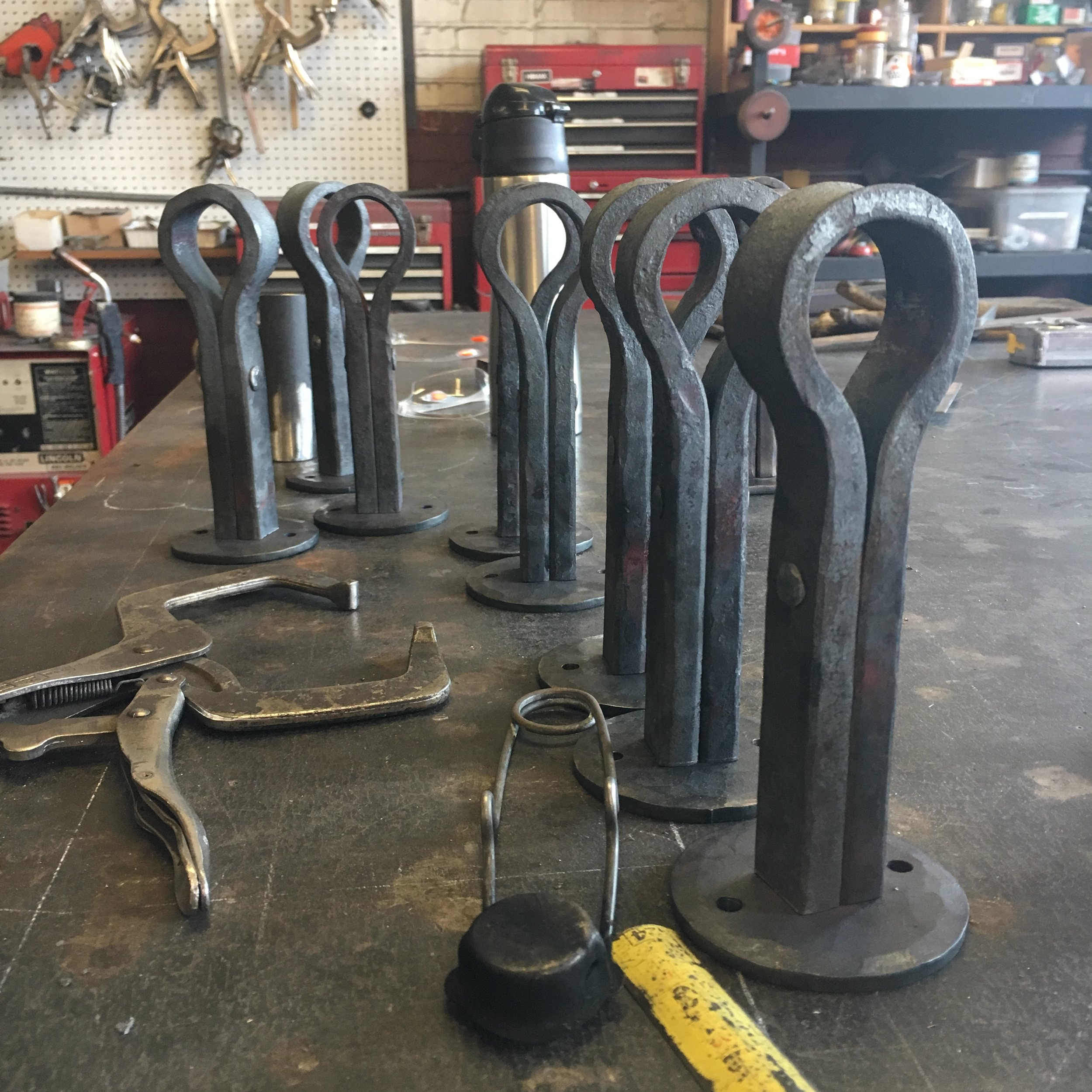 Forged custom bar foot bar rail brackets in process