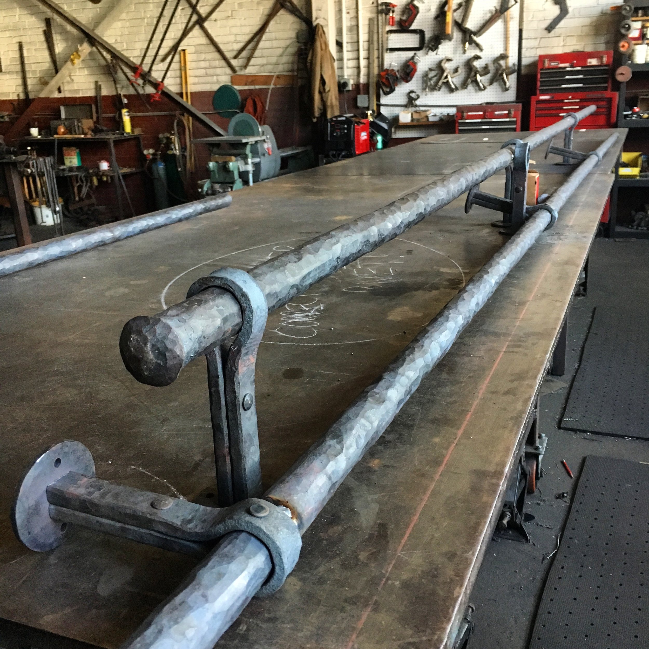 Forged custom bar foot rail in process