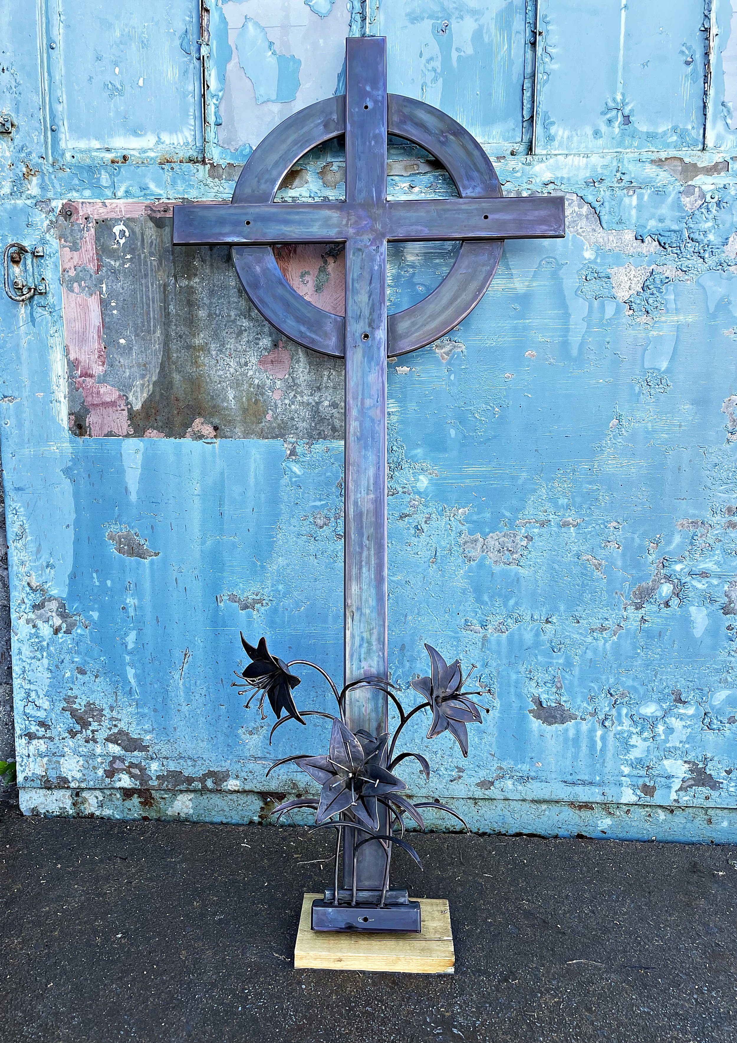 Bronze cross with forged lilies ready for install