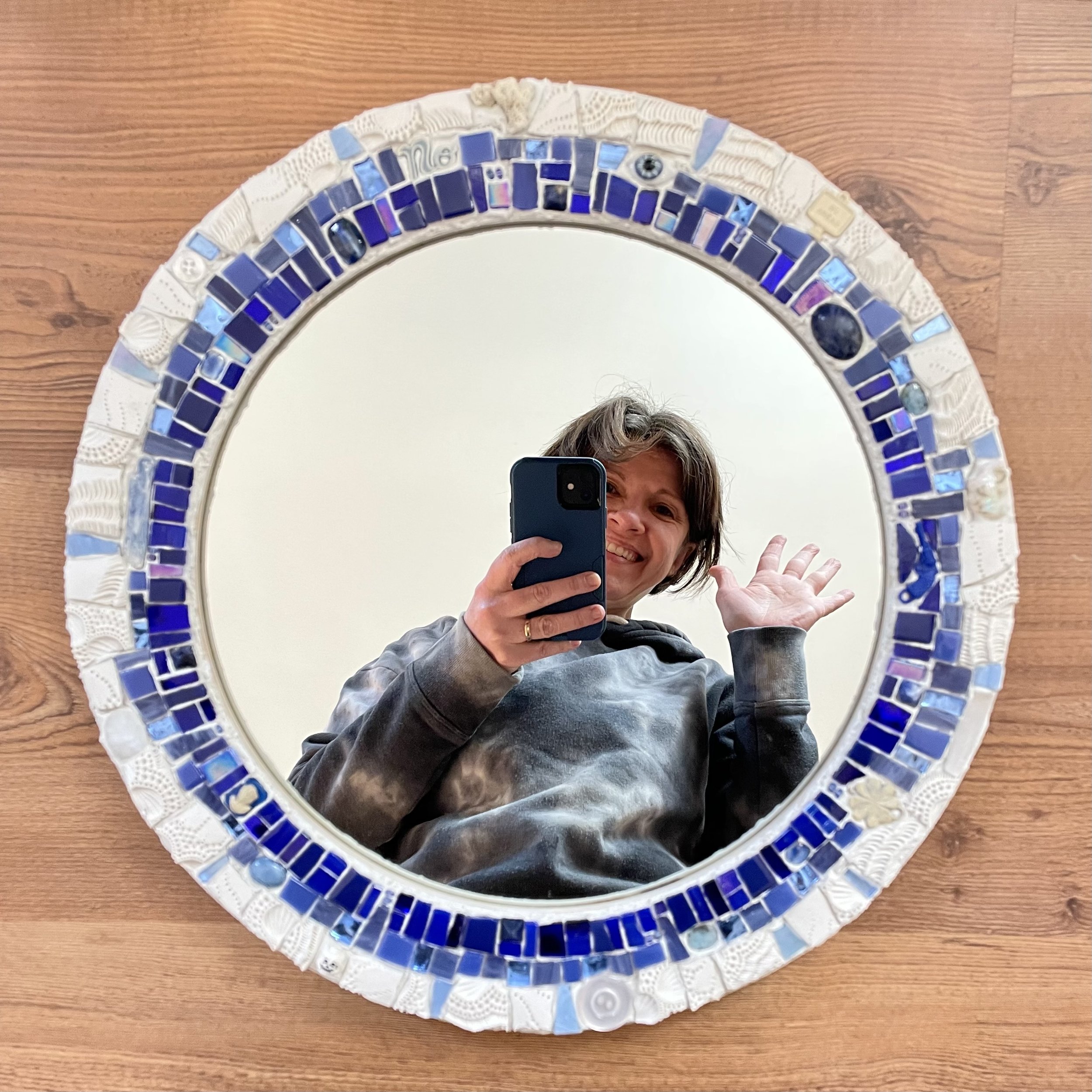 Custom round mosaic mirror with the artist