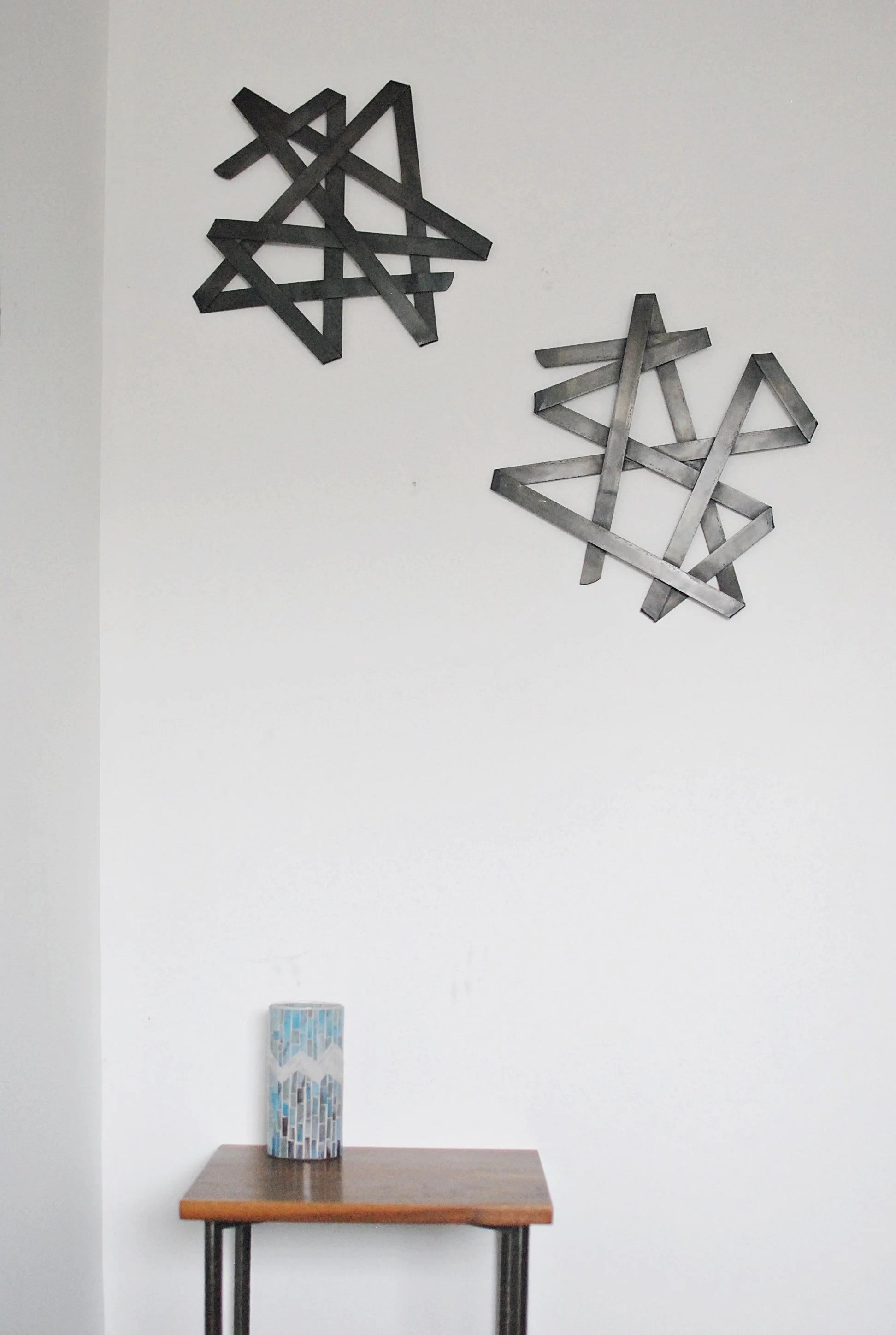 Abstract steel wall sculptures hanging on wall