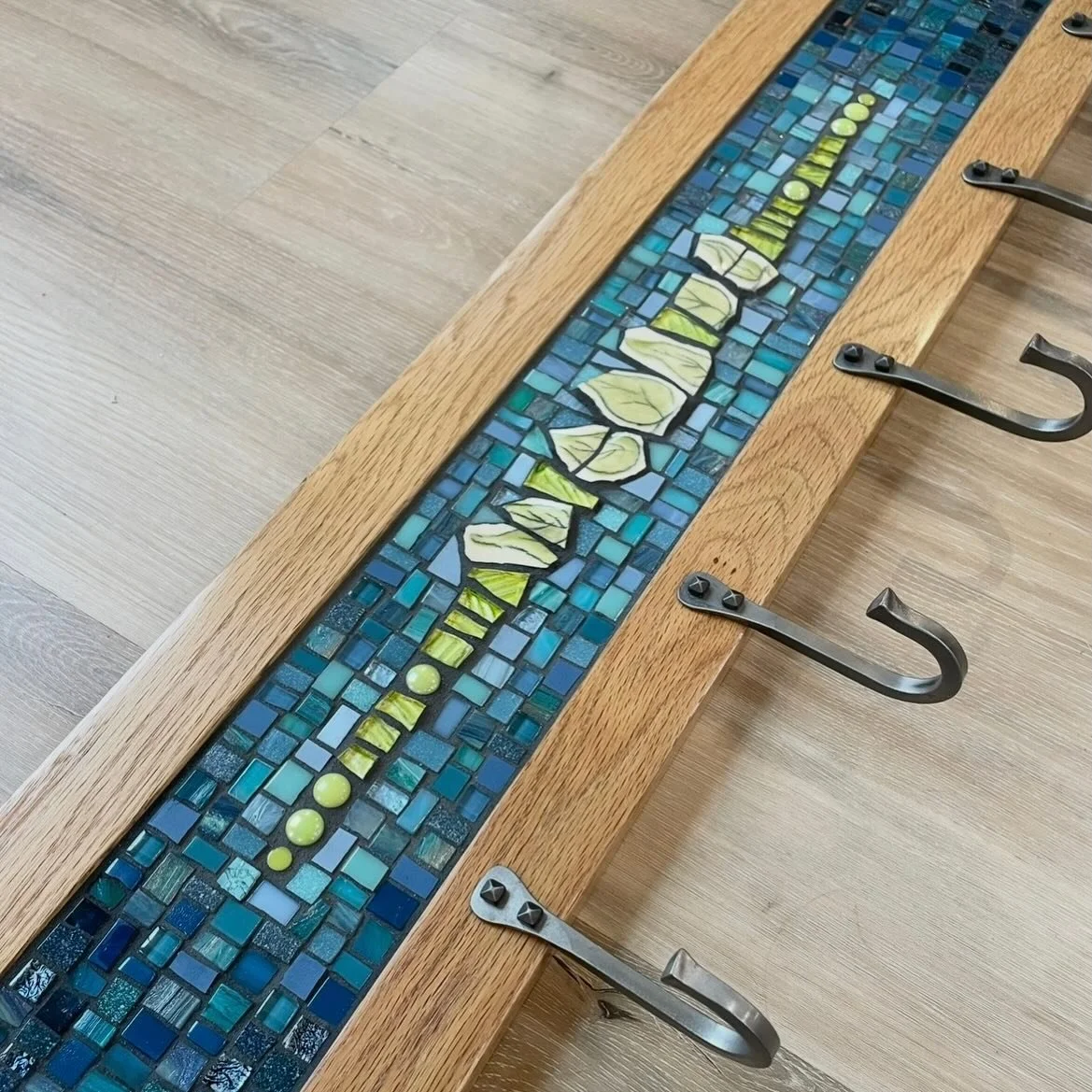 So pleased with the way this one worked out. 

Custom mosaic coat rack in many blues and greens inspired by the client&rsquo;s wallpaper. 🔹🩵🔹

The ceramic leaves are reclaimed from the talented @mariastonestudio&rsquo;s work. 🍃

Every custom piec