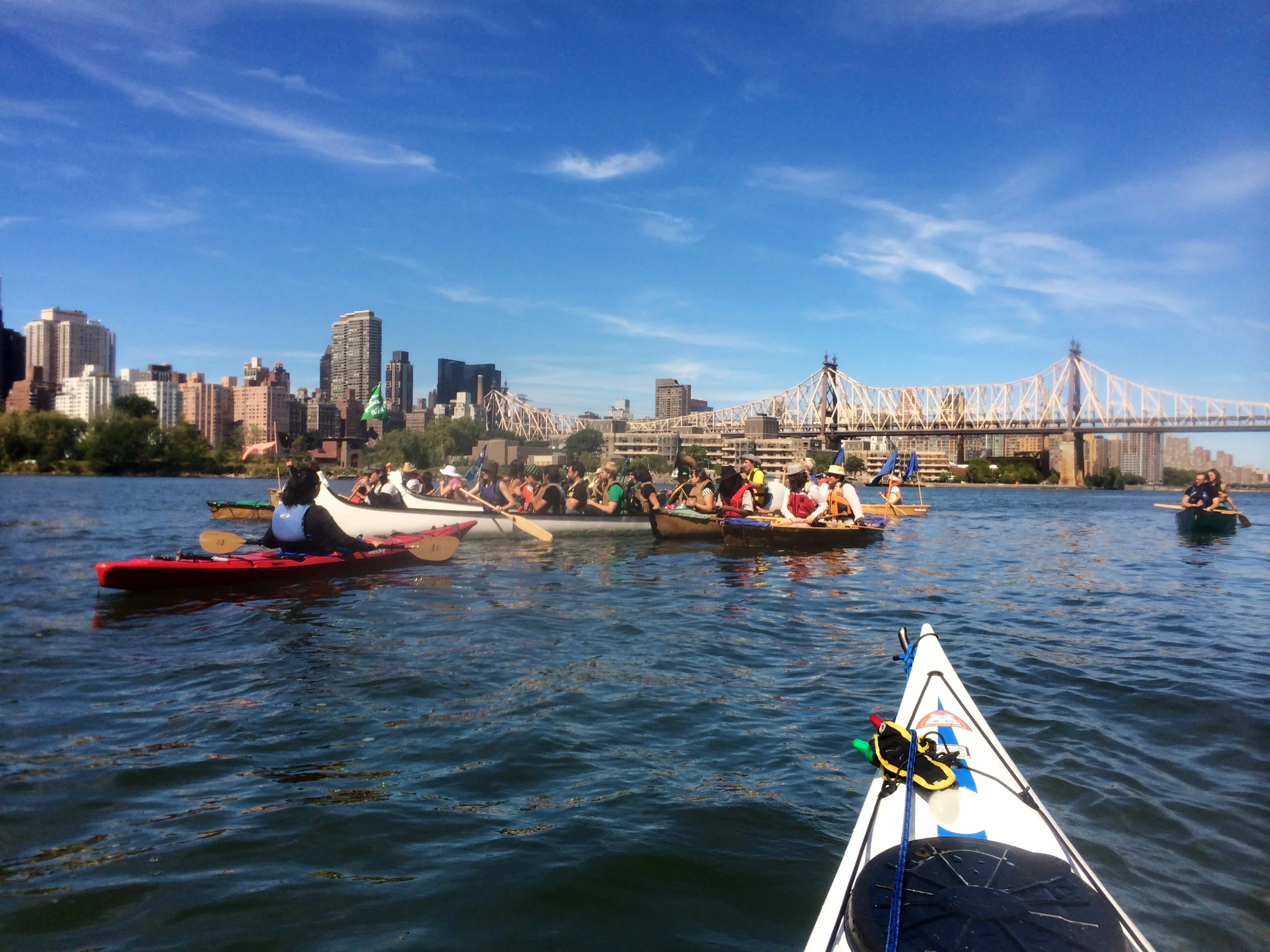 The Rude Mechanical Orchestra plays on canoes in the East River - photo by Stephen Wong