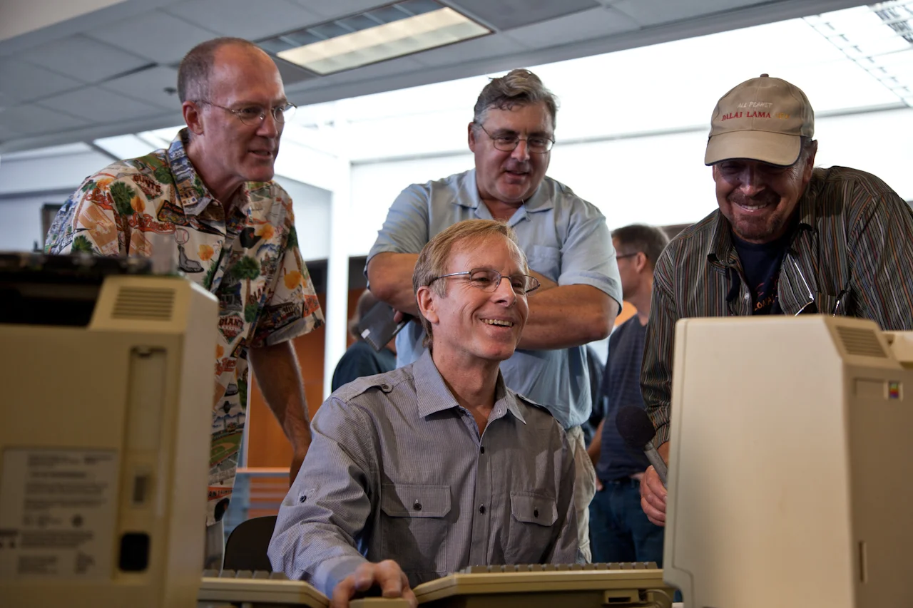 The Original MacWrite Team - Creator Randy Wigginton running the computer, with Ed Ruder (left) and Don Breuner (Center rear) looking on.