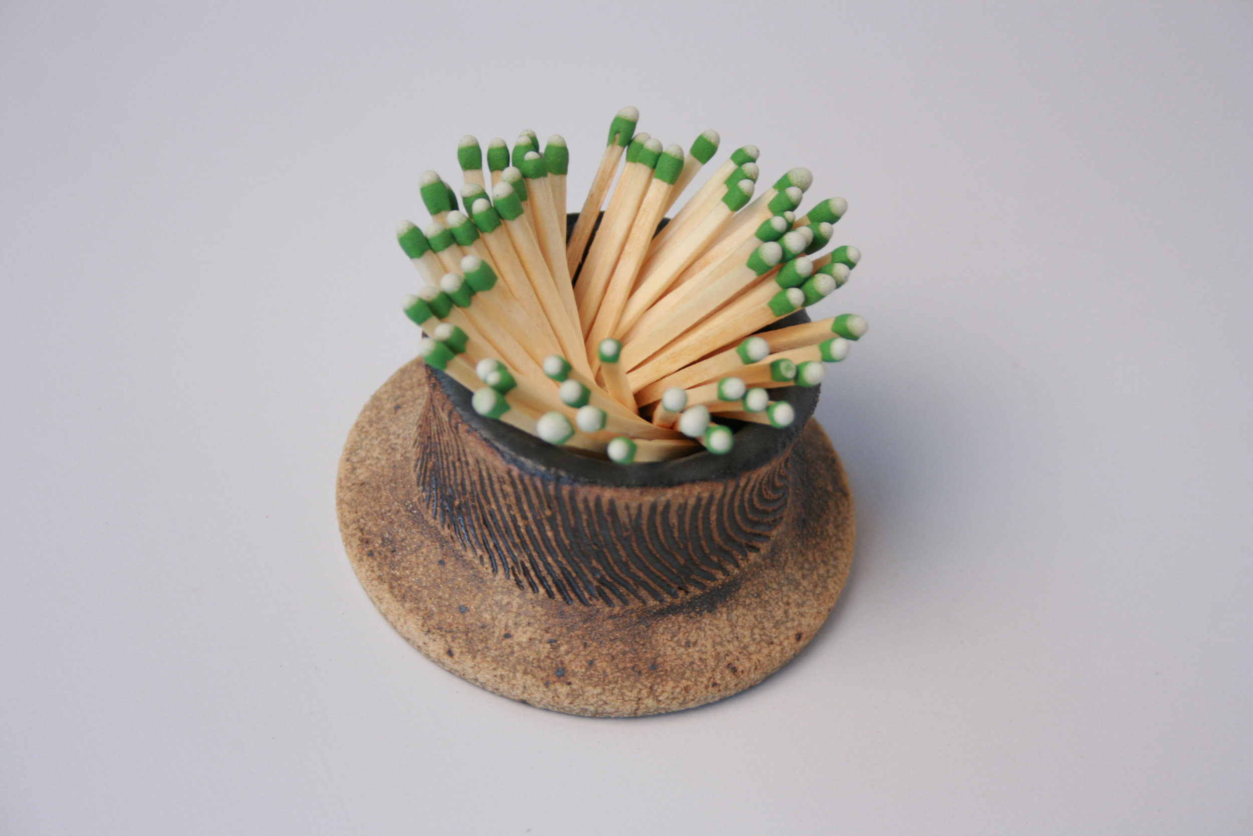 STORE AND LIGHT "STRIKE ANYWHERE" MATCHES WITH THIS PIECE 