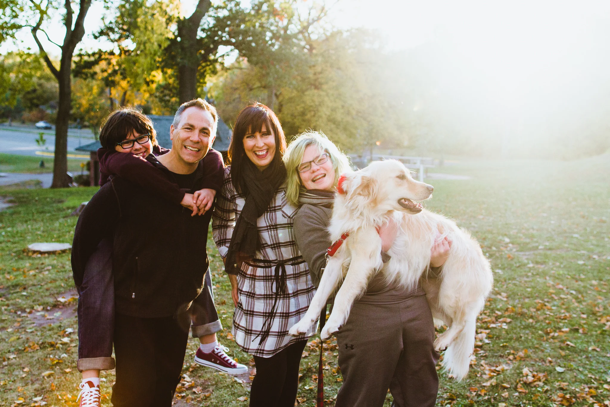 Family holding a golden retriever