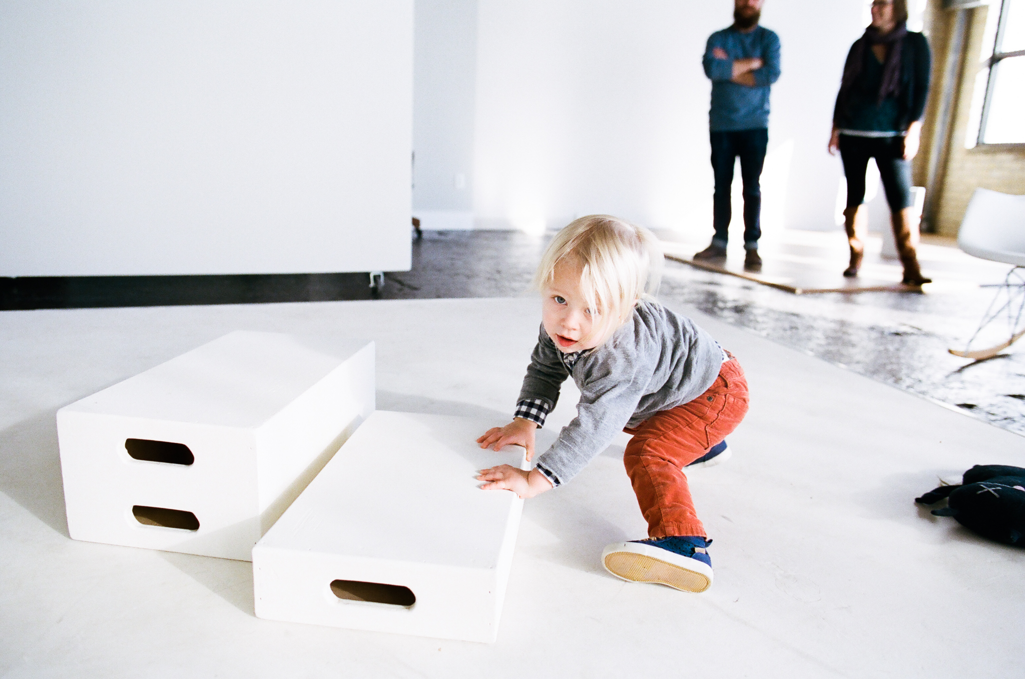 Young boy stacking apple boxes.