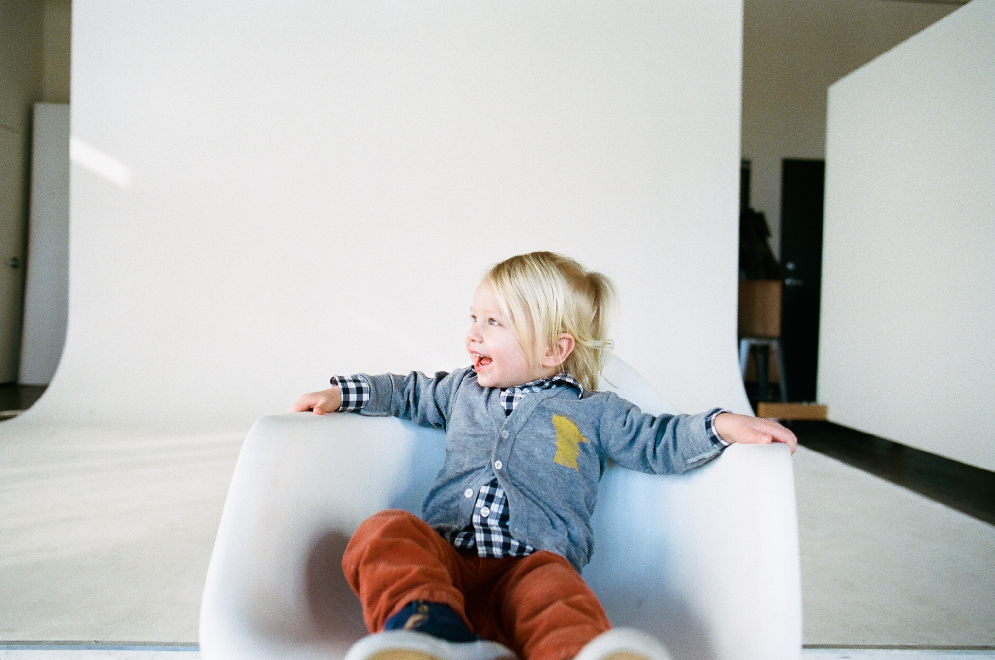 Laughing child in a natural light photo studio