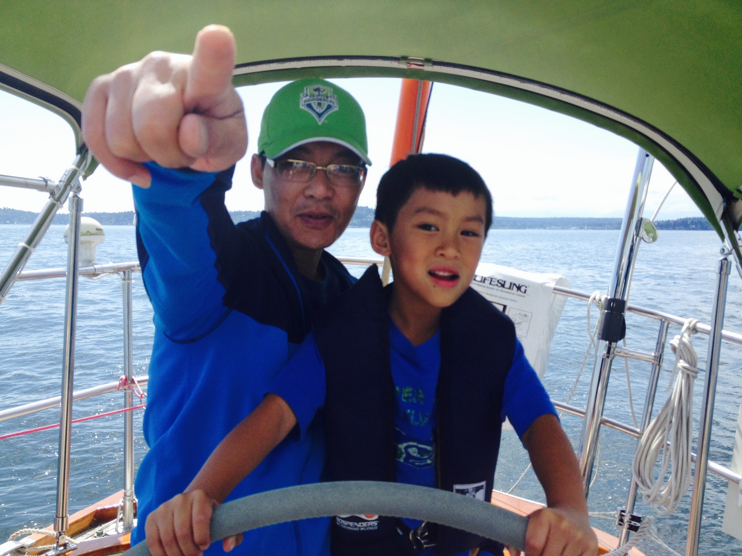 Papa Kiet navigates while Minh mans the helm.