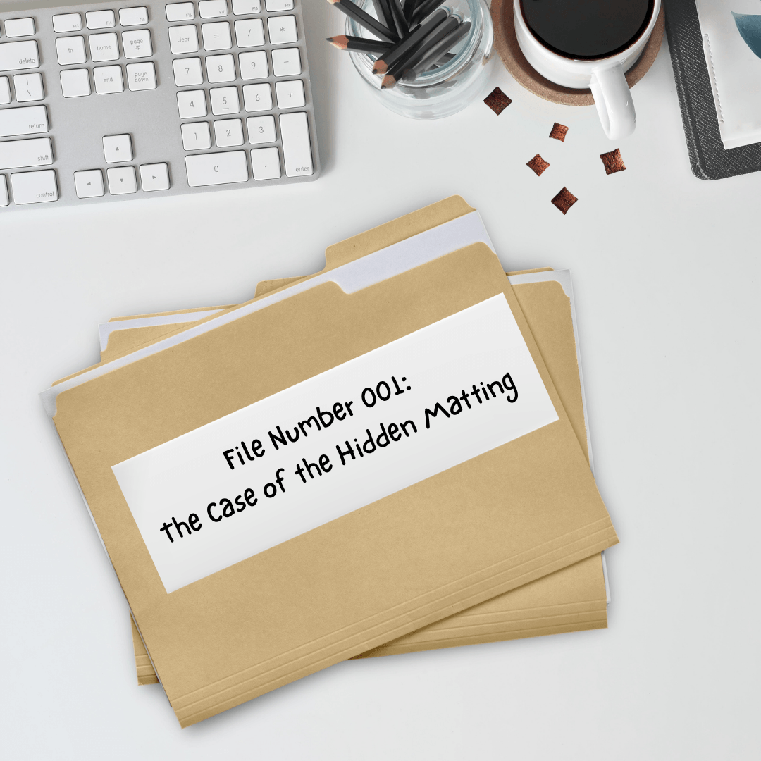 a white desk with a couple of file folders on it, the top one reads File Number 001: The case of the hidden matting
