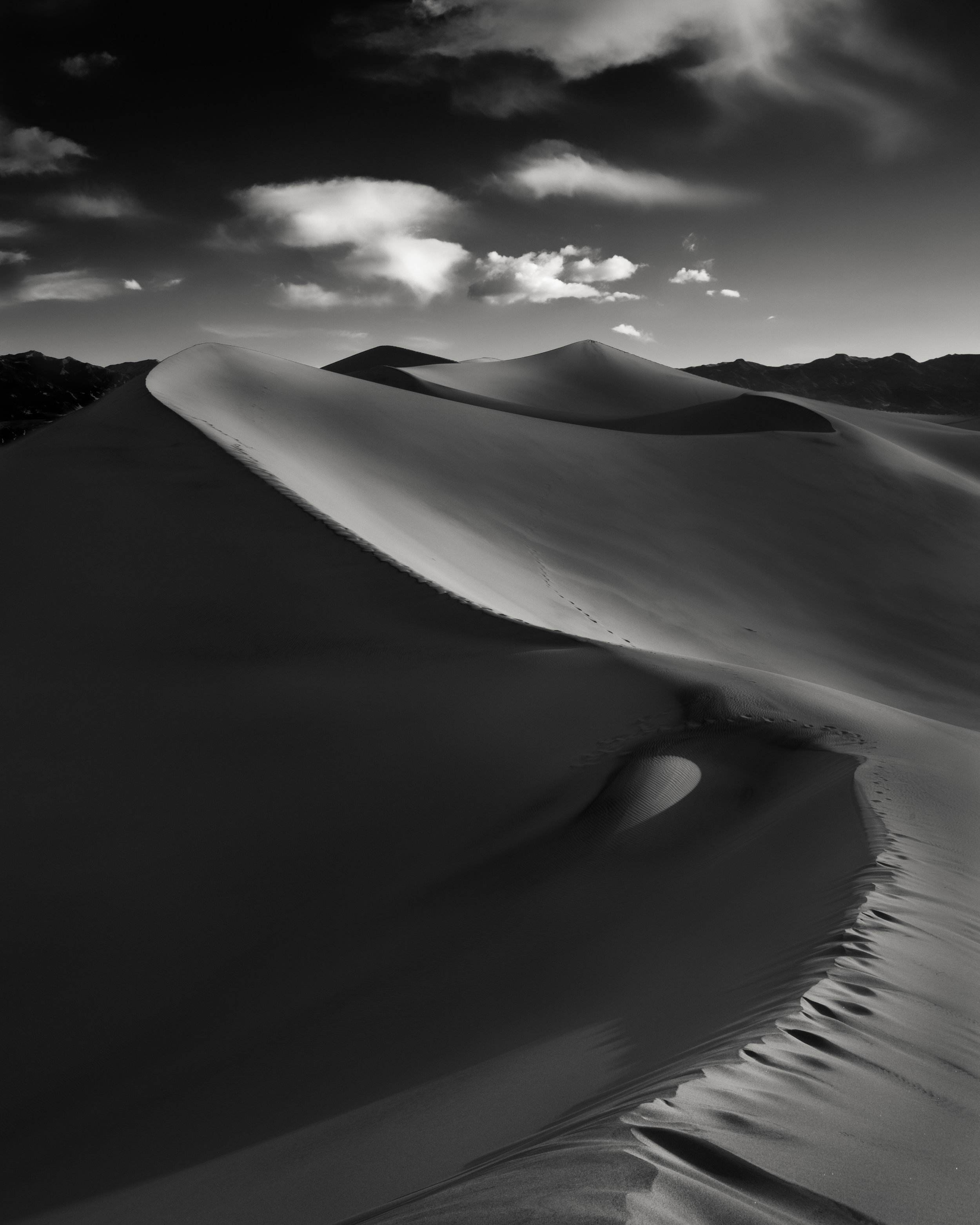 Death Valley black white sand dunes curve ridge serpentine