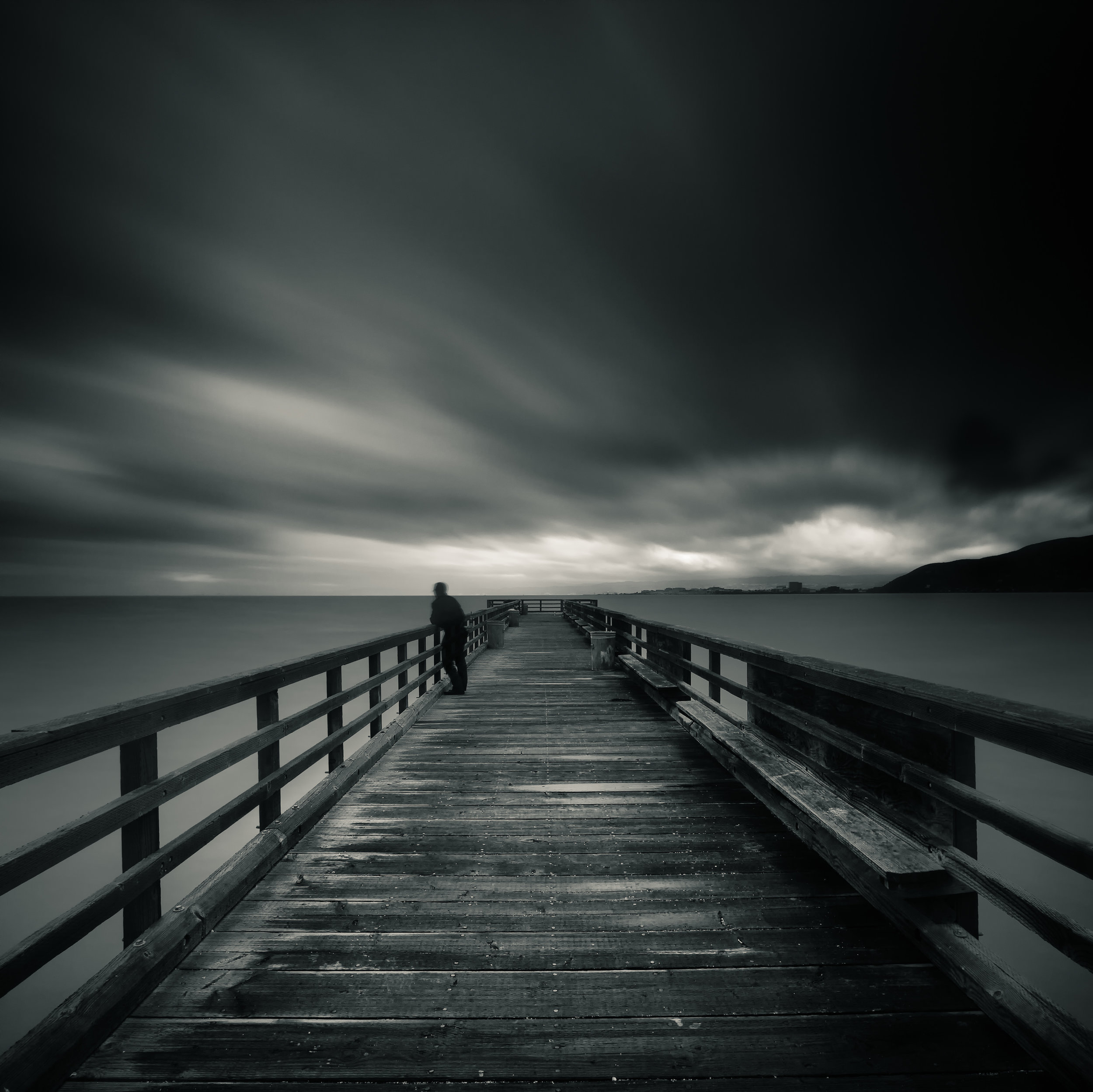 South San Francisco black white candlestick pier lone figure storm clouds