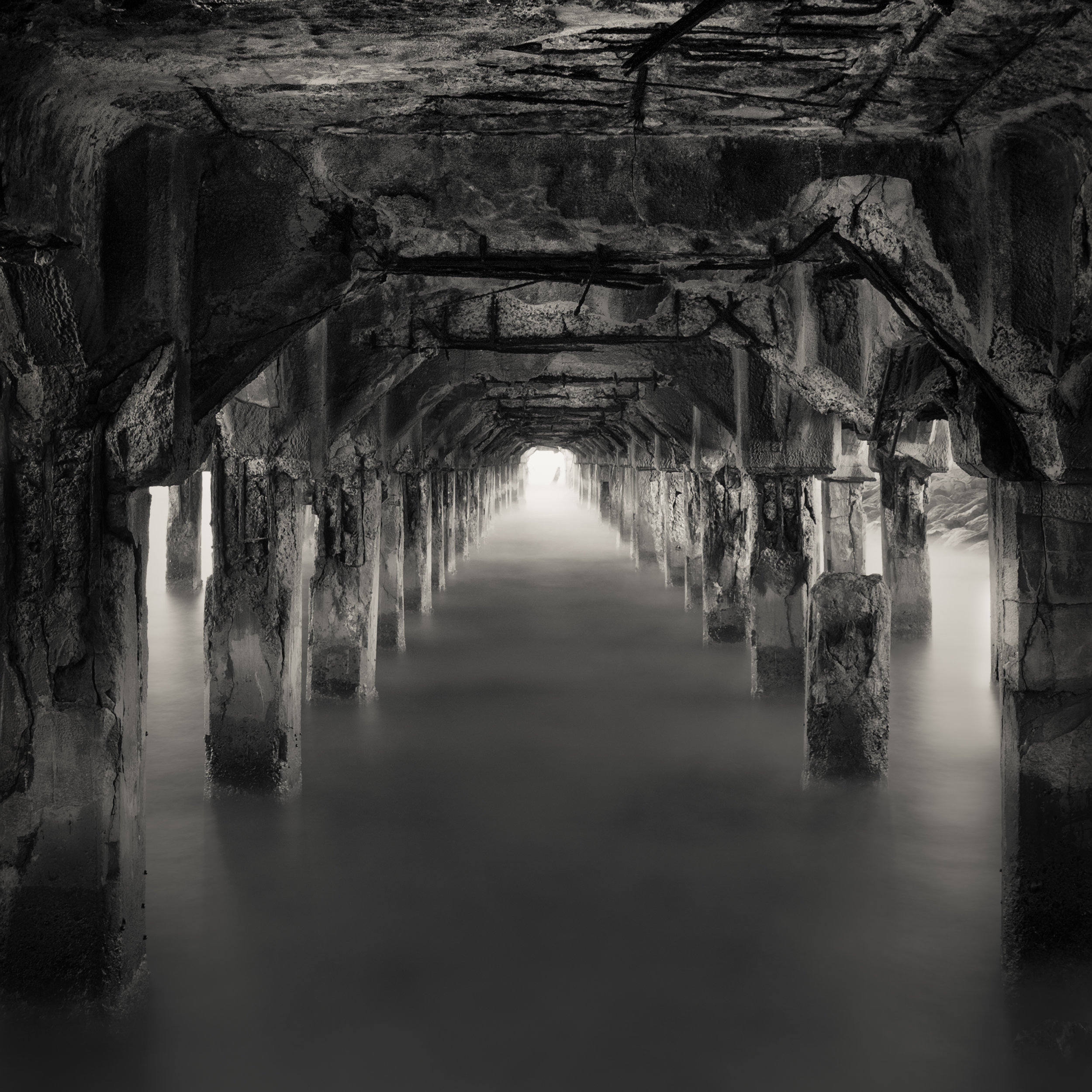 Maui Lahaina black white pier remains underneath catacombs