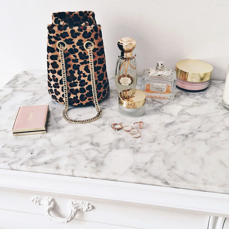 The Rue Saint-Honoré Mini Bucket Bag is now available in our super-chic Leopard , the same that we use for our iconic zip pouches. The perfect size for bright winter days & starry nights out, this mini bucket bag is lightweight and just large enough to hold the essentials. + shop here