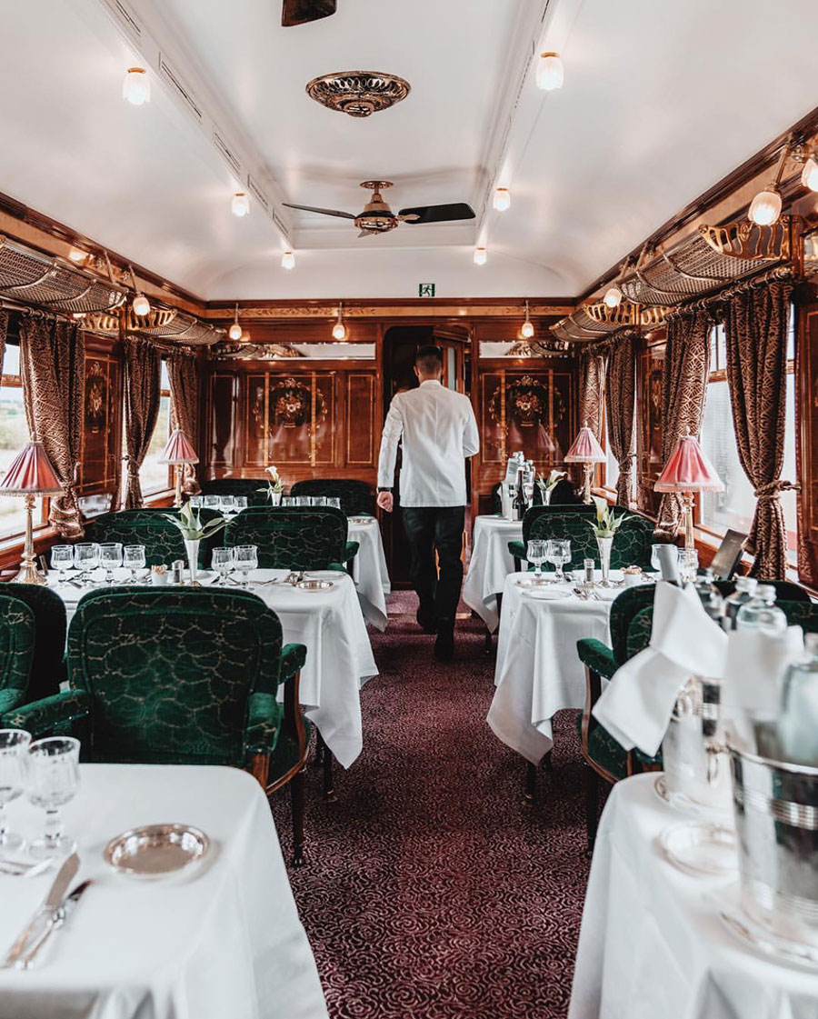 "Three elegant dining carriages exude culinary sophistication, from Lalique glass inlays in Cote d’Azur to black lacquer panels in L’Oriental. The Bar Car glows with a champagne sparkle while the resident pianist fills the air with sweet melodies." …