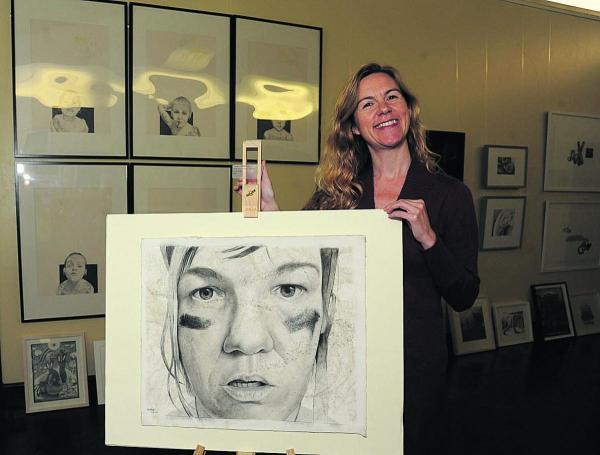 Tracy Sullivan, art director at Trowbridge Town Hall, with a roller derby portrait by Megan Foldenauer – one of the Derwent Art prize exhibits in the Town Hall
