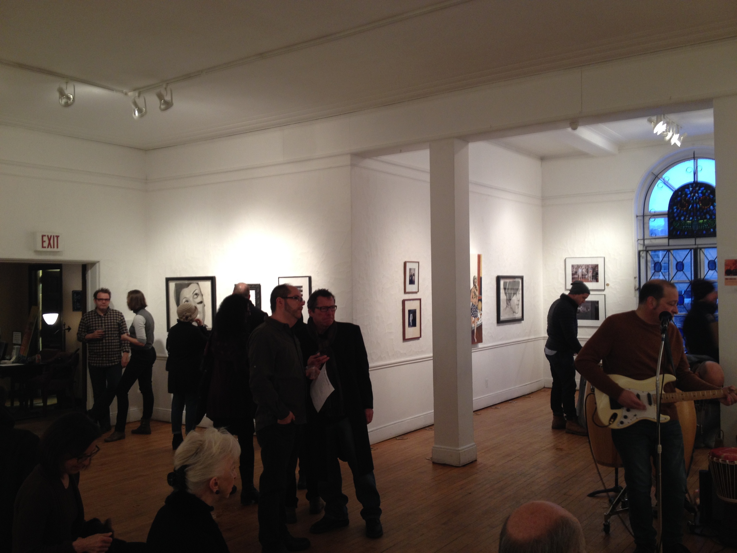 The portraits, in situ , on opening night. Michigan Basement is playing on the right.