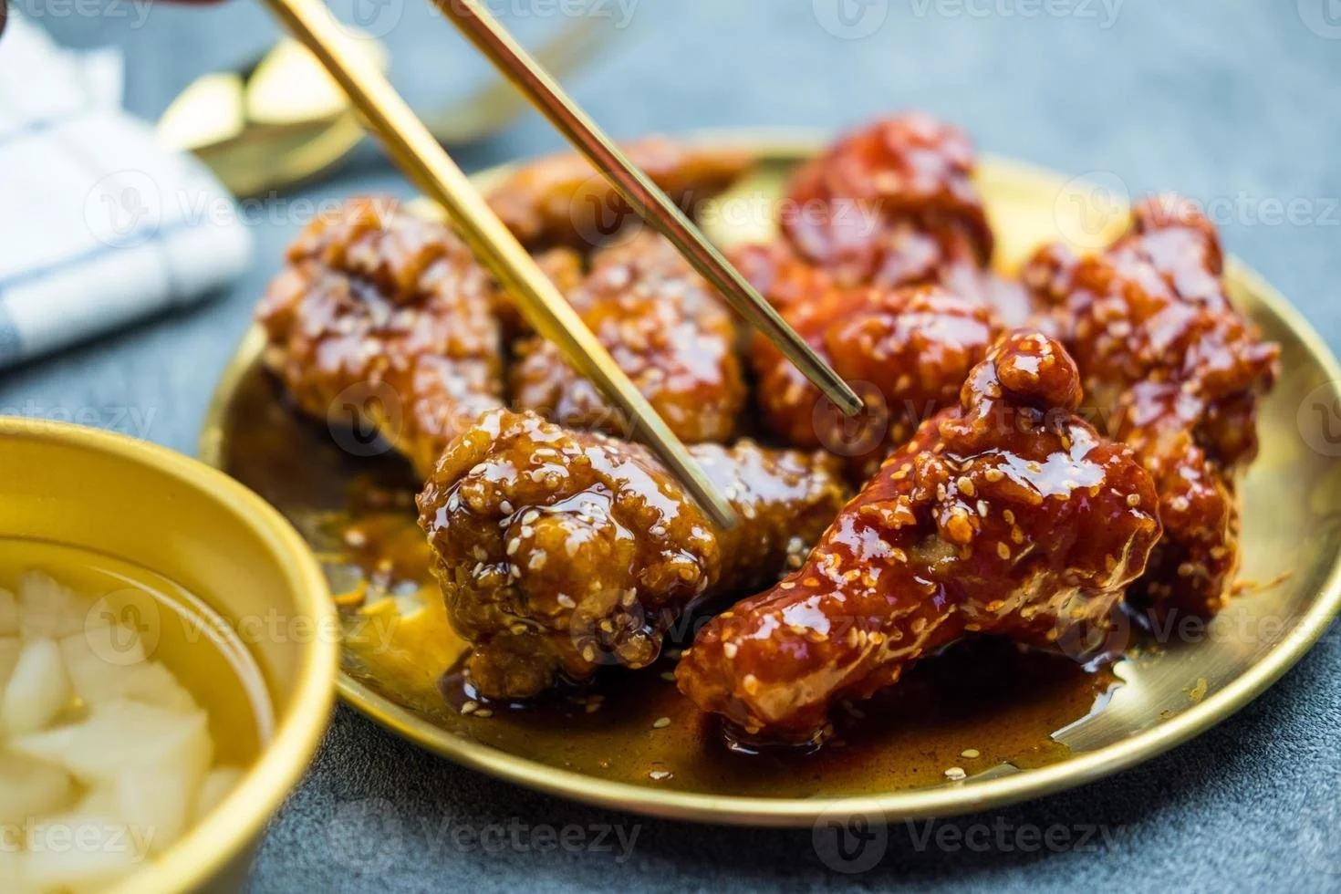 deep-fried-chicken-wing-with-garlic-sauce-and-spicy-sauce-in-korean-style-served-with-pickled-radish-photo.jpg