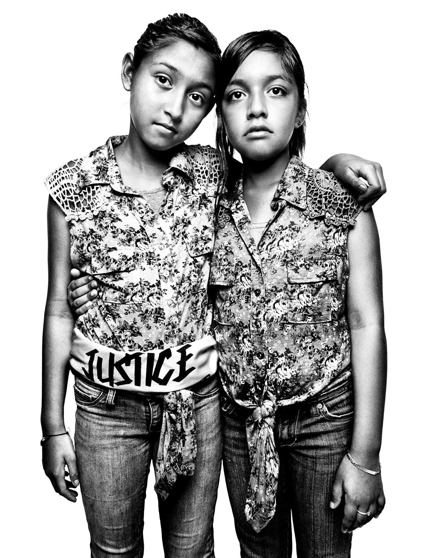 Jacqueline Rayos (R), and Mayra Lovatos, both 11, are cousins and US citizens. But Jacqueline's mother and Mayra's aunt, Guadalupe Garcia de Rayos, is undocumented. She was arrested in 2008 in a raid conducted by Sheriff Joe Arpaio of Maricopa County and eventually put into deportation proceedings. After a public campaign by the immigrant advocacy group Puente, Guadalupe was granted a one-year stay of removal. Jacqueline and Mayra were photographed after a protest organized by Puente Arizona in front of Immigration and Customs Enforcement headquarters in Phoenix, Arizona, on July 29, 2013, a few days after Guadalupe's stay was granted. On February 8, 2017 -- during her annual appointment with immigration officials -- agents arrested Guadalupe and began procedures to send her back to Mexico, a country she has not seen since she left 21 years ago. 