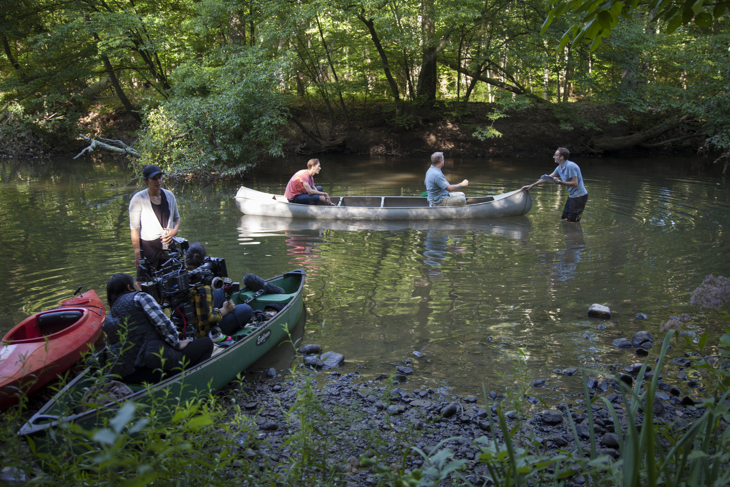  While the camera crew loads into their canoe, Jeff Ryan and Brian Haley rehearse in the water with director Tim Young. 