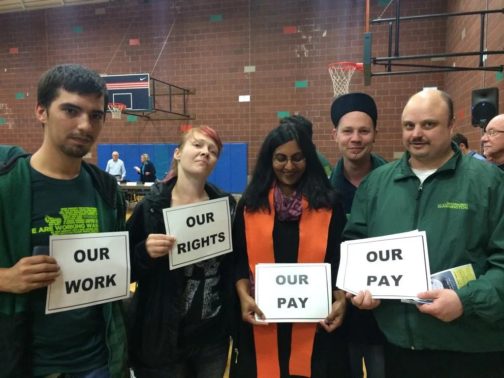 Councilmember Kshama Sawant with fast food workers before the hearing, supporting strong enforcement of $15.