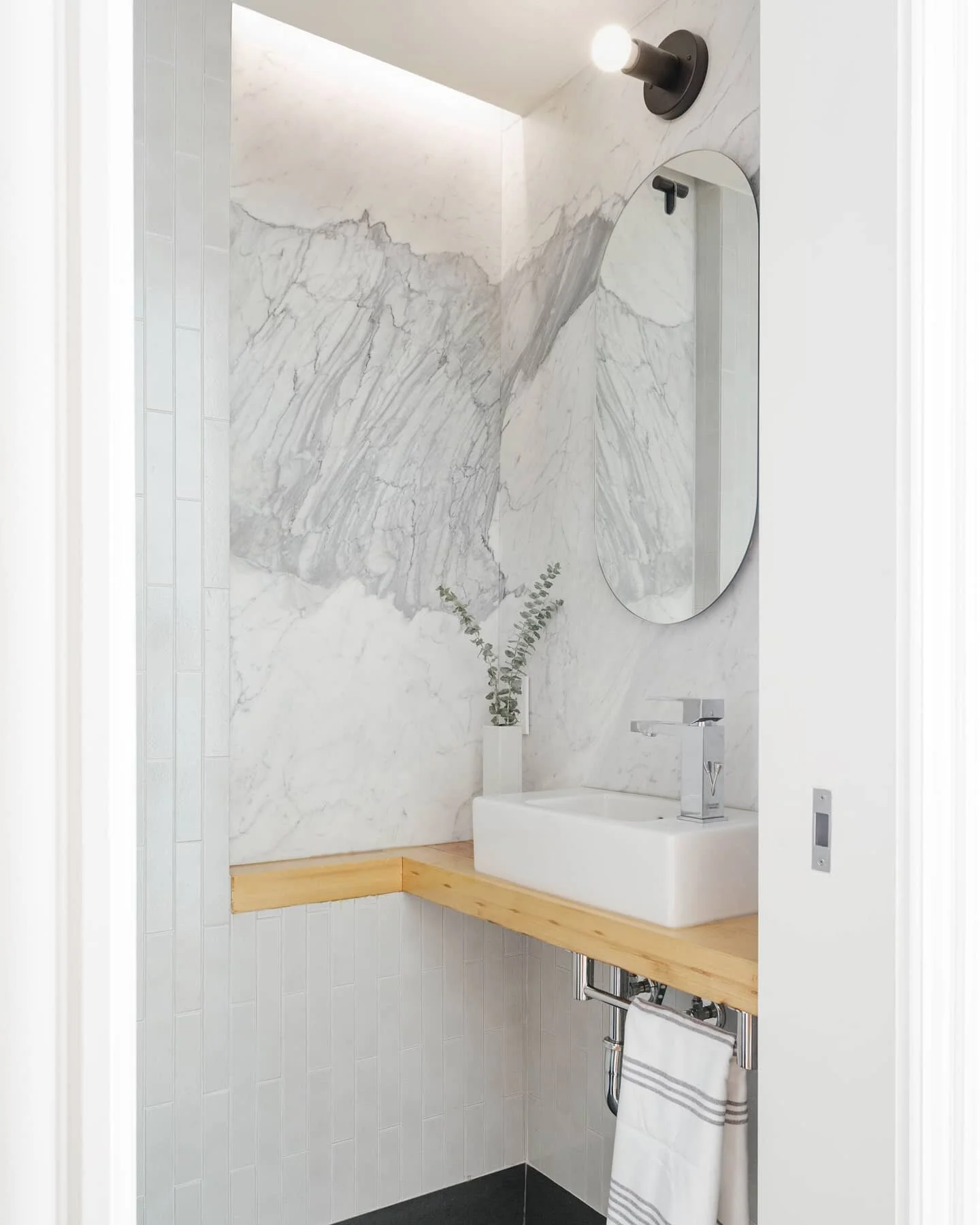We love the huge splash of grey in this honed Statuarietto. Powder room, Sunset Park Townhouse. For the vanity, we sanded and reused a roof beam taken down in the demo process. Photos: @nickglimenakis 

#janekimdesign #interior #architecture #bathroo