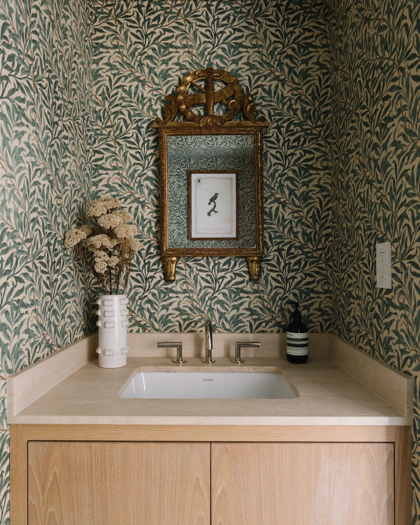 Custom vanity, Lower Fifth Avenue Apartment. Leftover travertine from the main bathroom makes for a perfect counter on the white oak cabinet. Delightful @wmorrisandco Willow Boughs wallpaper wraps the space. 📸 @nickglimenakis 

#janekimarchitect #ar