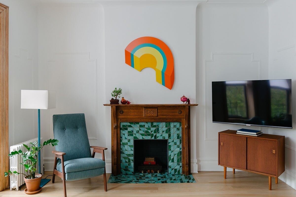 The Park Slope Apartment living room mantel is the result of many happy accidents. The client found the antique tiger oak mantel on the street, though it was missing a top. @heathceramics tile modernized the design and we sourced salvaged white oak b