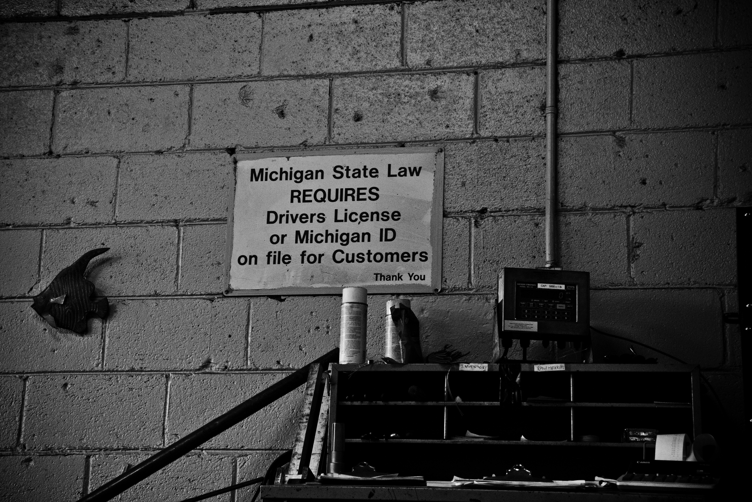 Signs decorate the loading scales to ensure those scrapping metal understand the strict policies. H&H Metals, Detroit. 