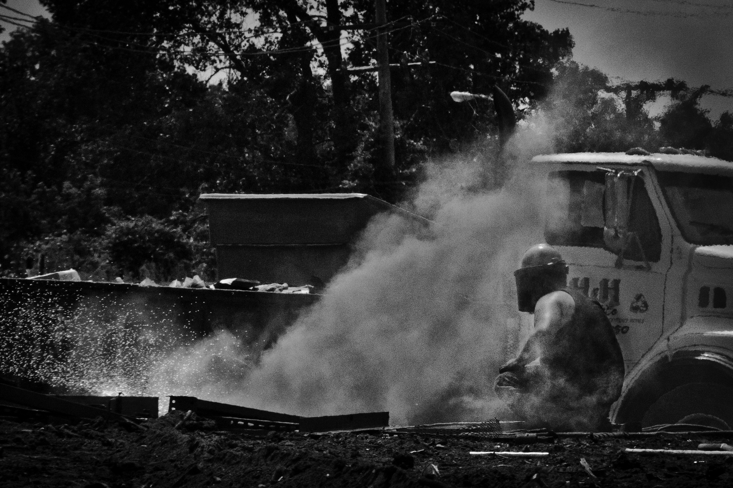 An employee cuts through metal beams at H&H Metals, Detroit. 