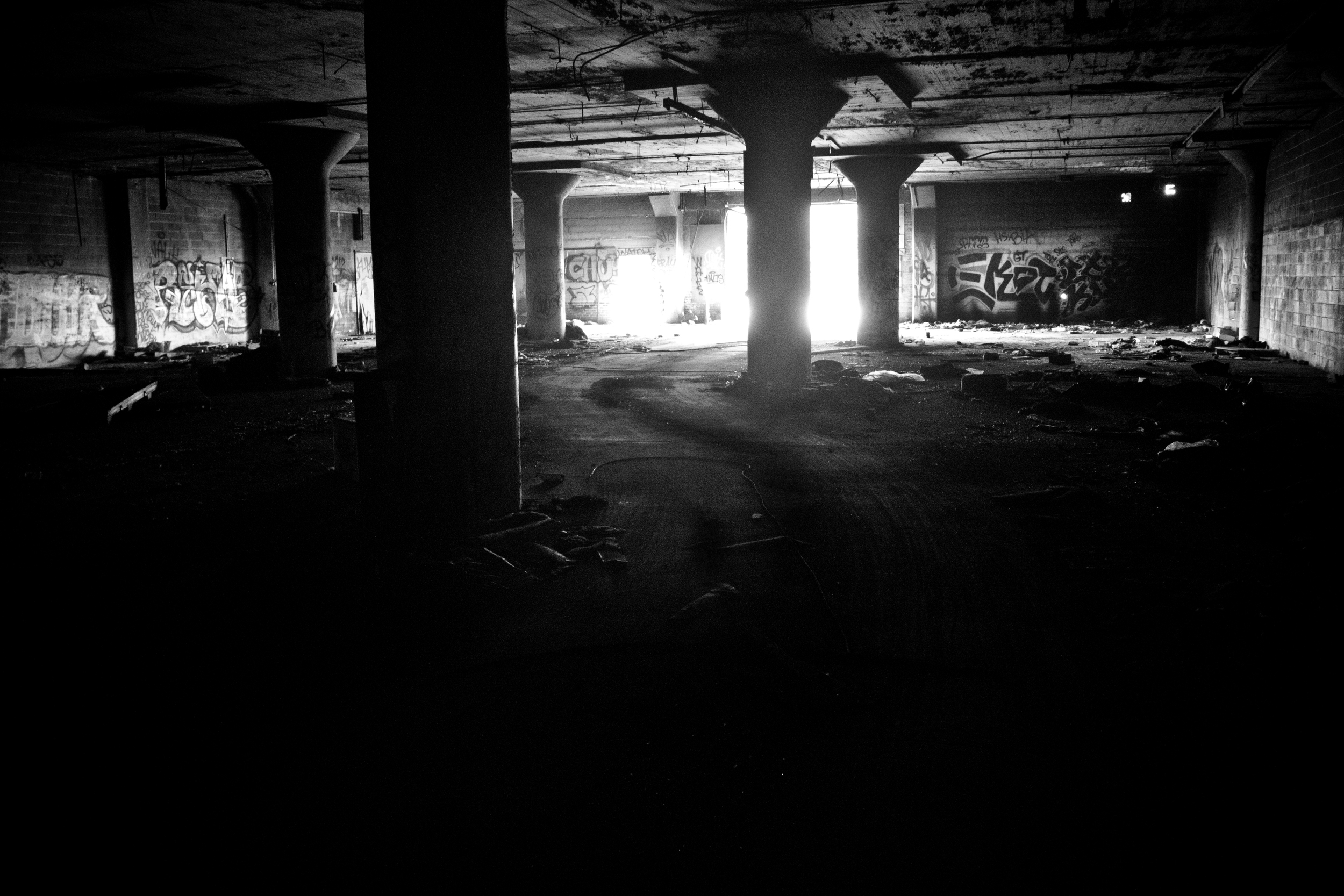 A makeshift road cuts through the Packard Plant of Detroit. Many of the abandoned plants are completely blocked off. Scrappers breakdown walls and clear rubble to provide routes for their vehicles. 