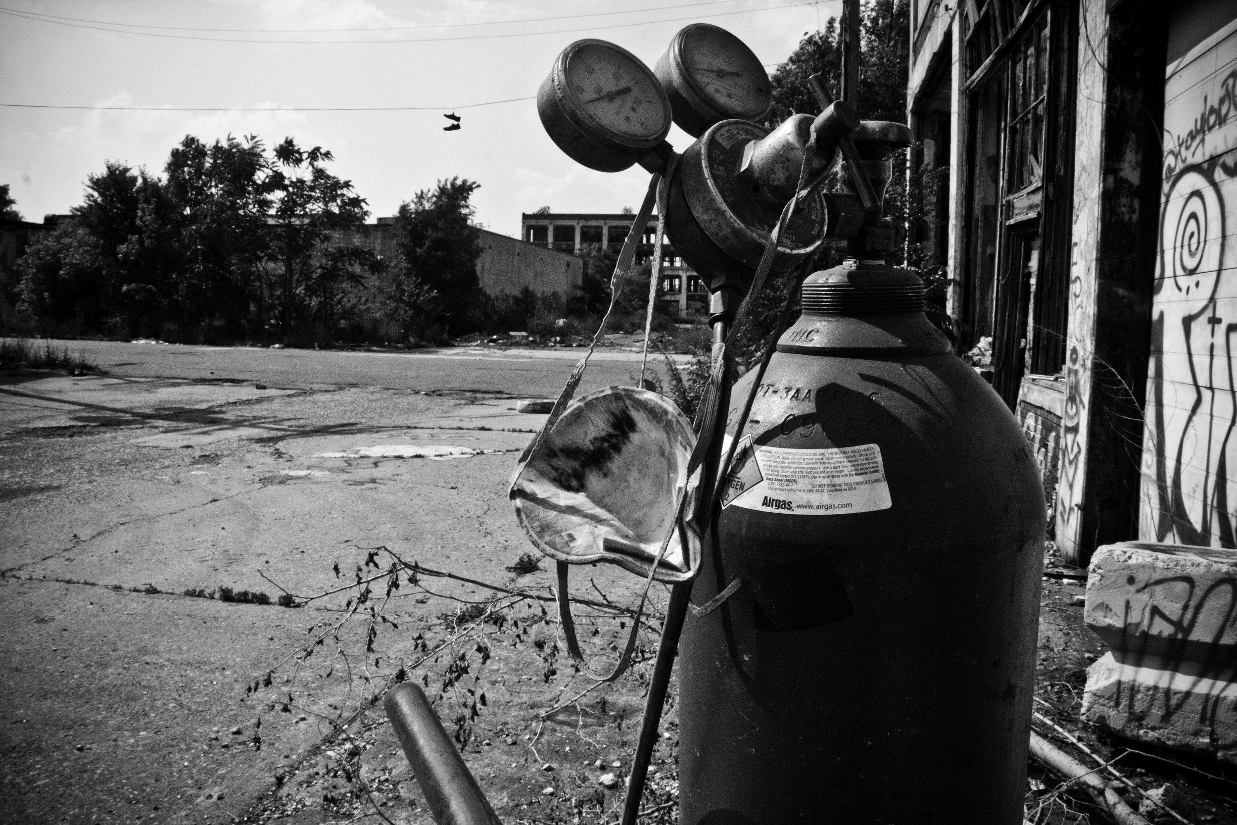  A mobile torch and tank sit outside an entrance to the Packard Plant while a scrapper searches inside for valuable metal.&nbsp; 