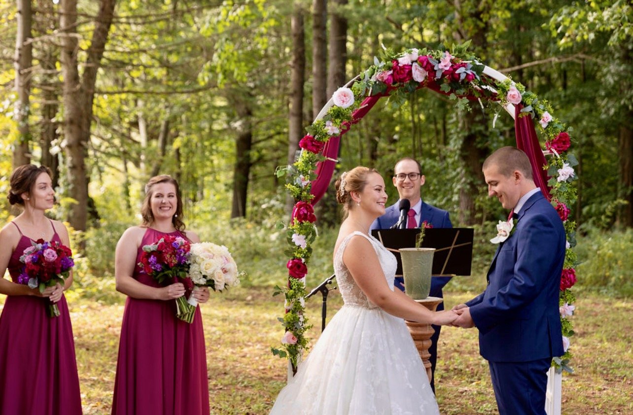 Vows beneath rose canopy BVM.jpeg