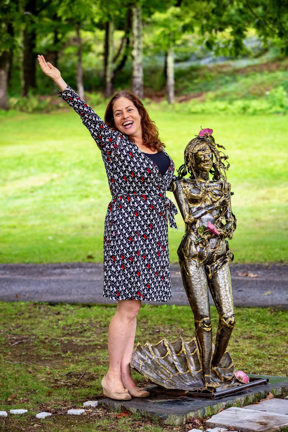 a person standing next to a statue
